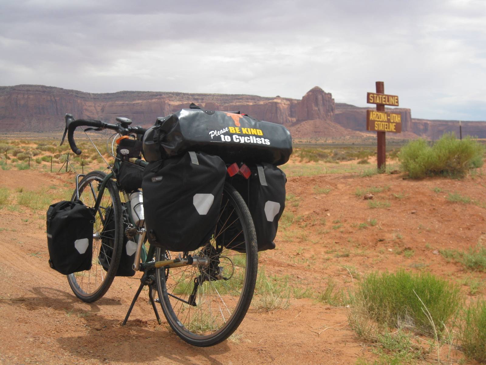 One of Landauer's bikes laden with saddle bags, parked on the side of a trail in a remote area in the American Southwest. 