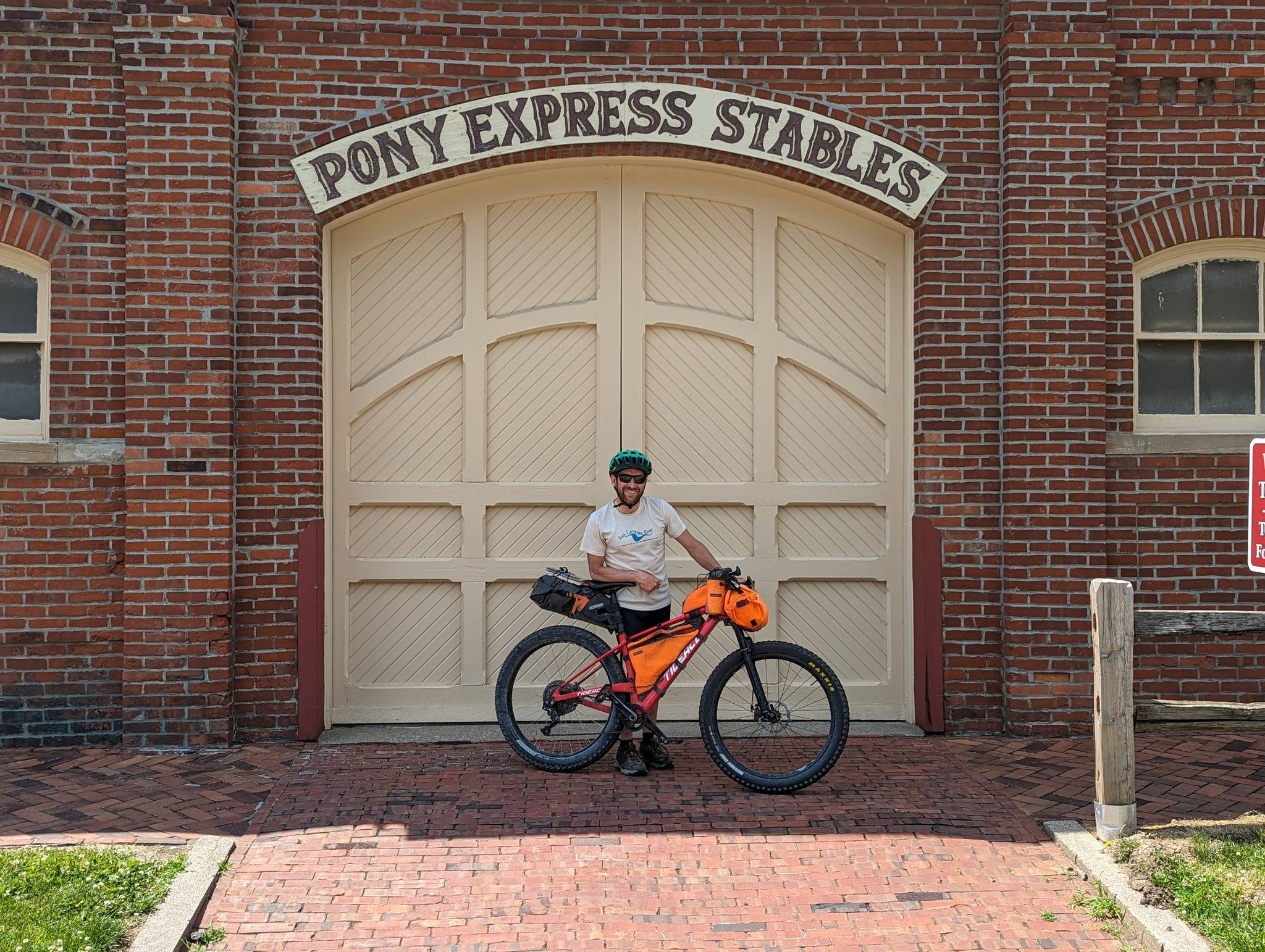 Rob Landauer poses with his bike at the iconic Pony Express Stables after finishing a ride tracing their route.