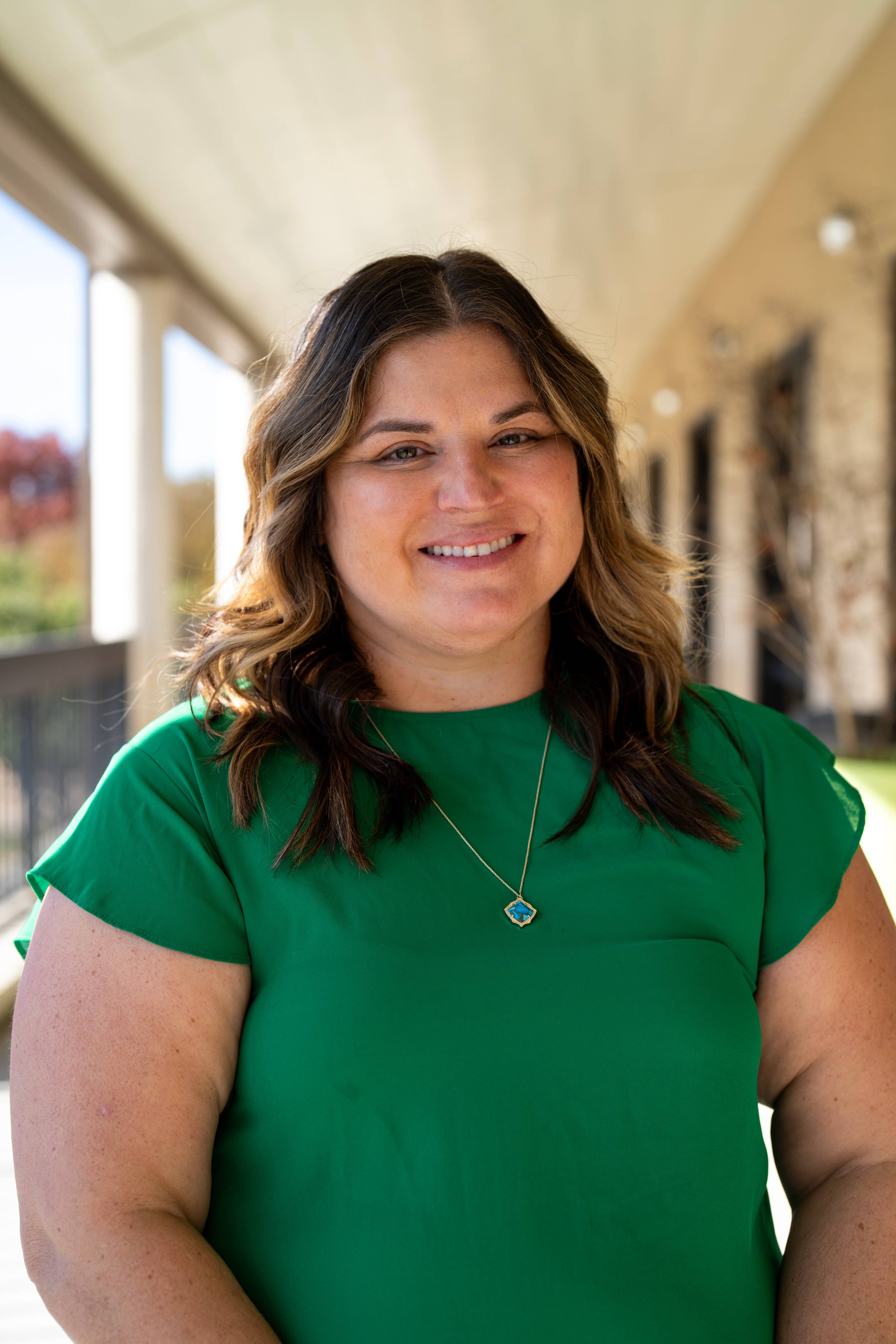Headshot of Dr. Brenda Rodriguez wearing a green shirt