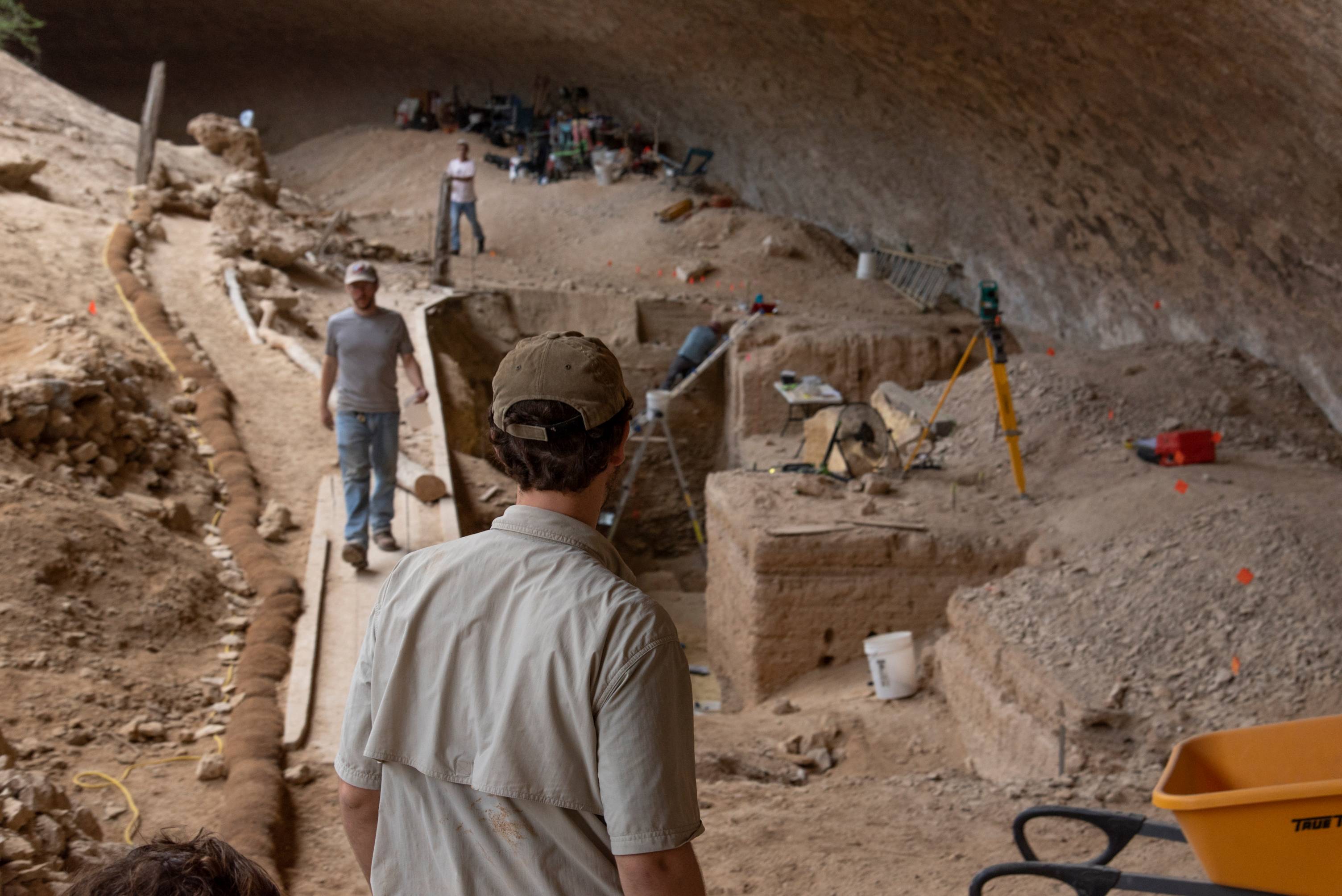 Student looking over digging site.