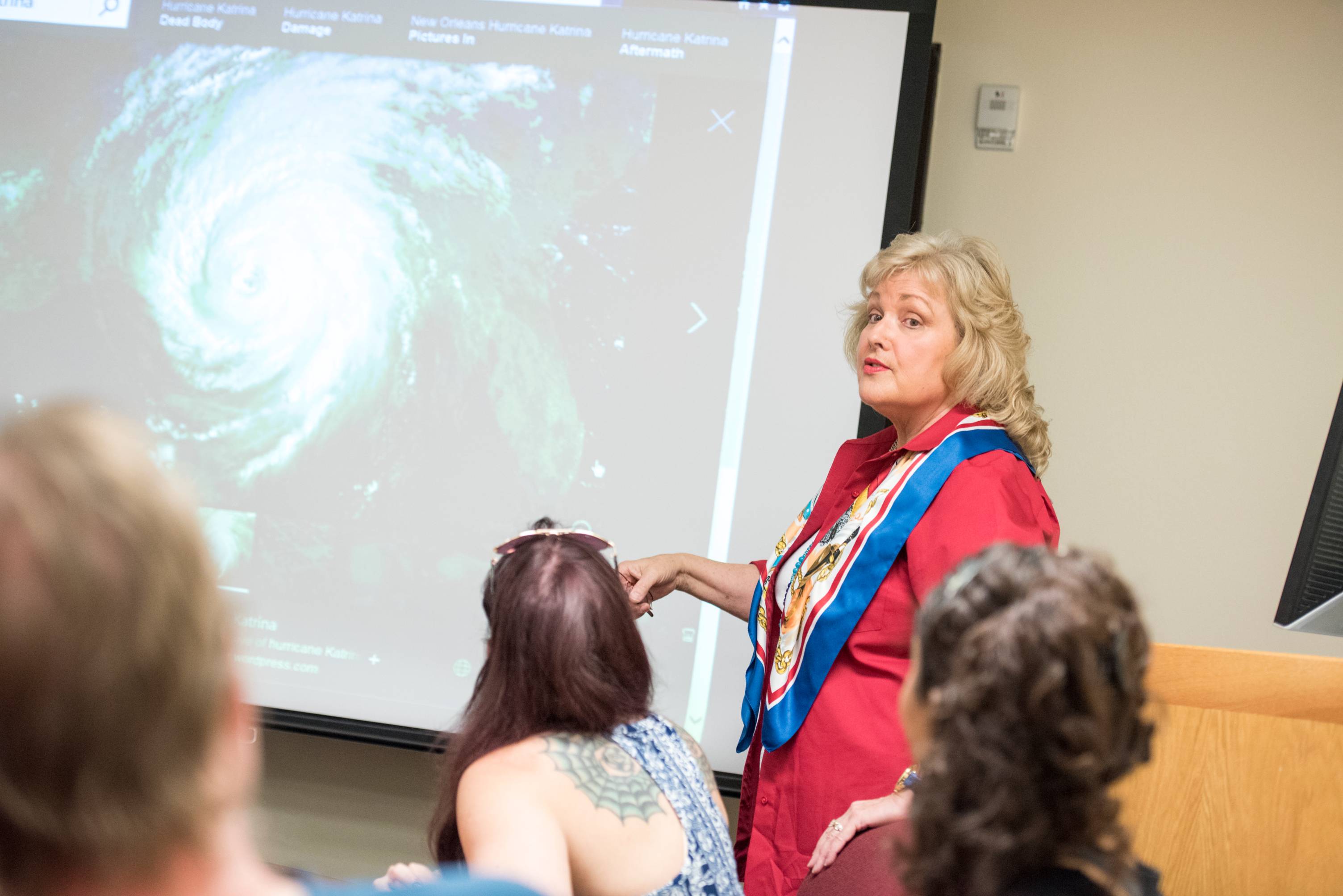 Professor explaining powerpoint presentation to students. 