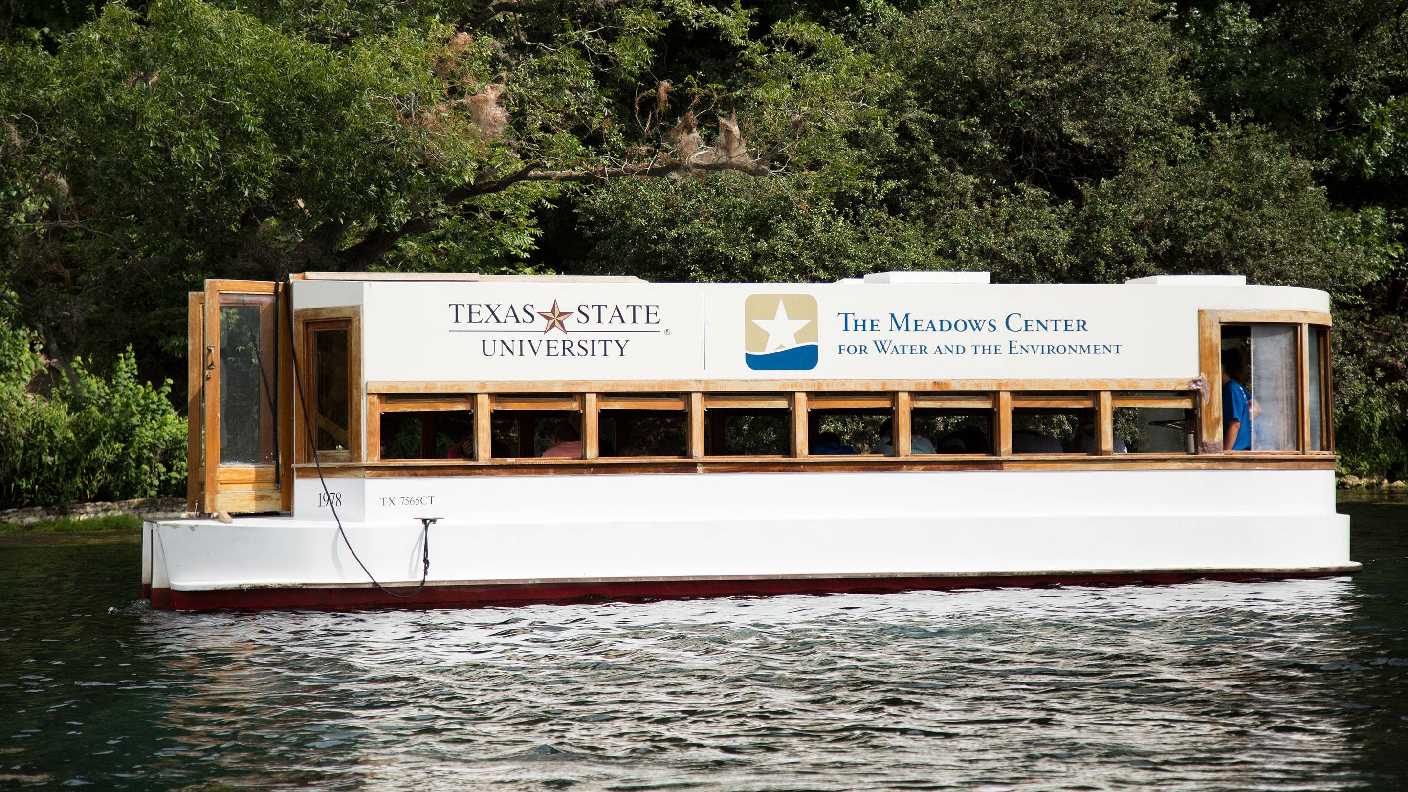 A glassbottom boat drives across Spring Lake.