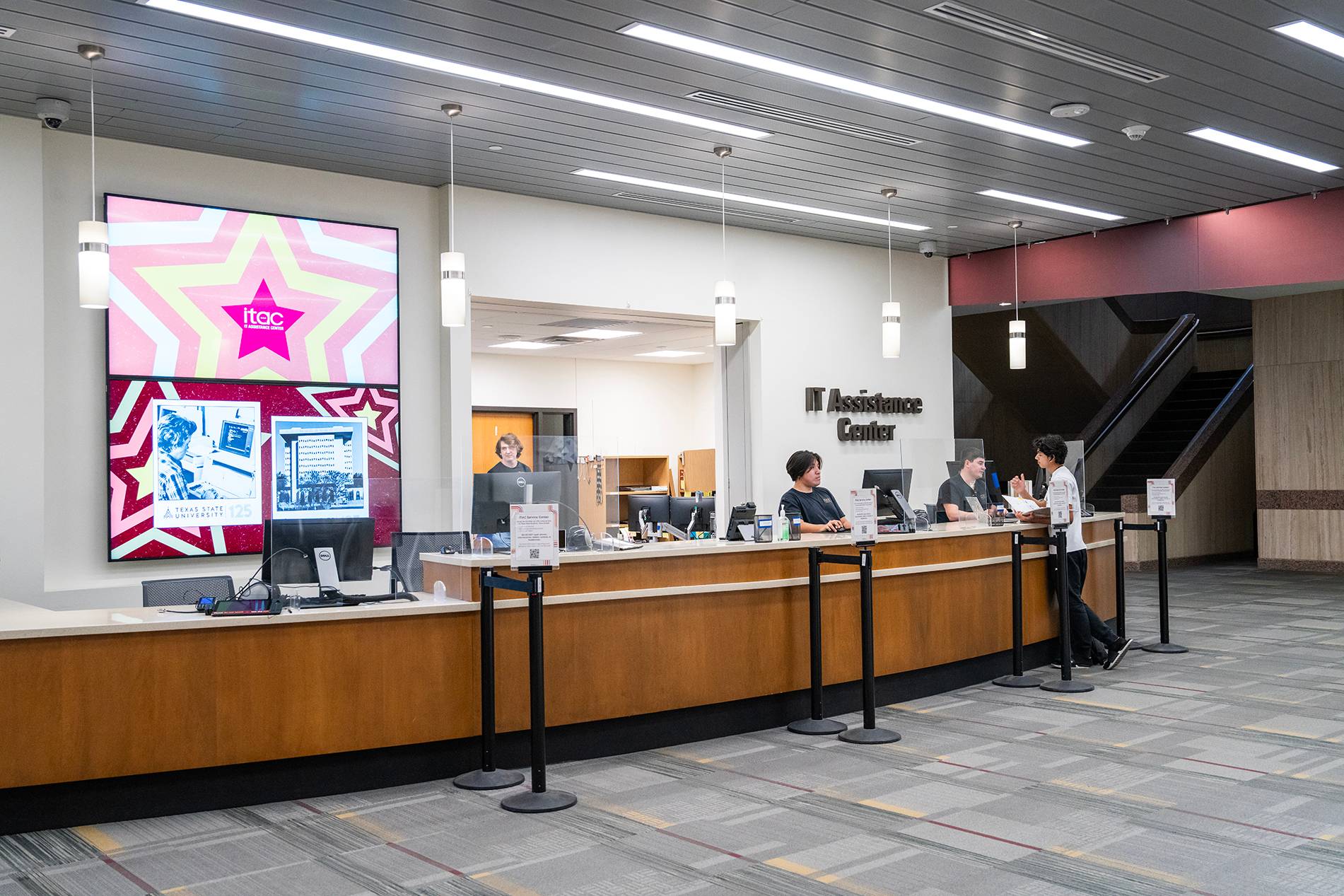 digital signs on wall above help desk