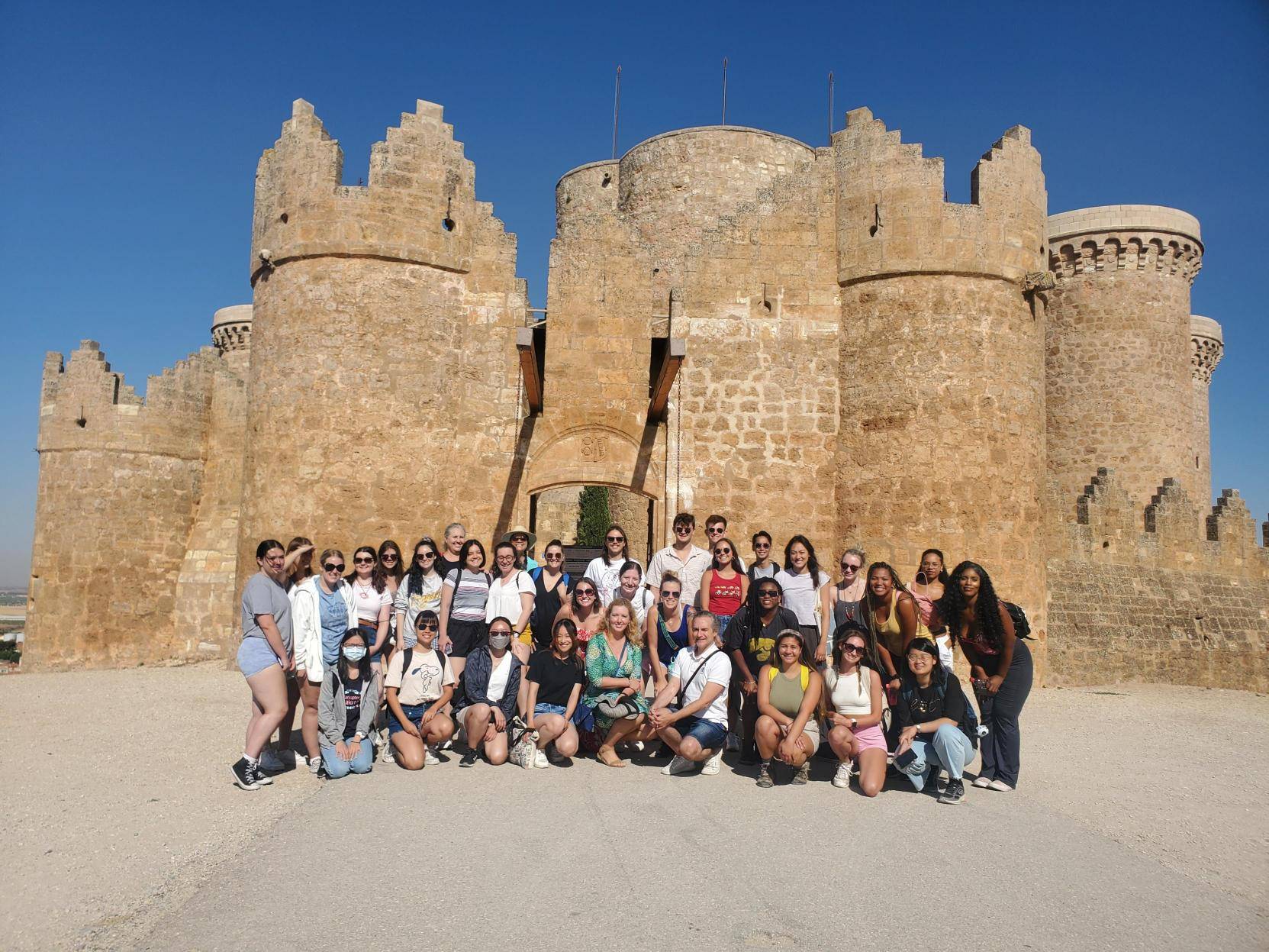 Group of students standing in front of the historic Castillo de Belmonte in Cuenca, Spain