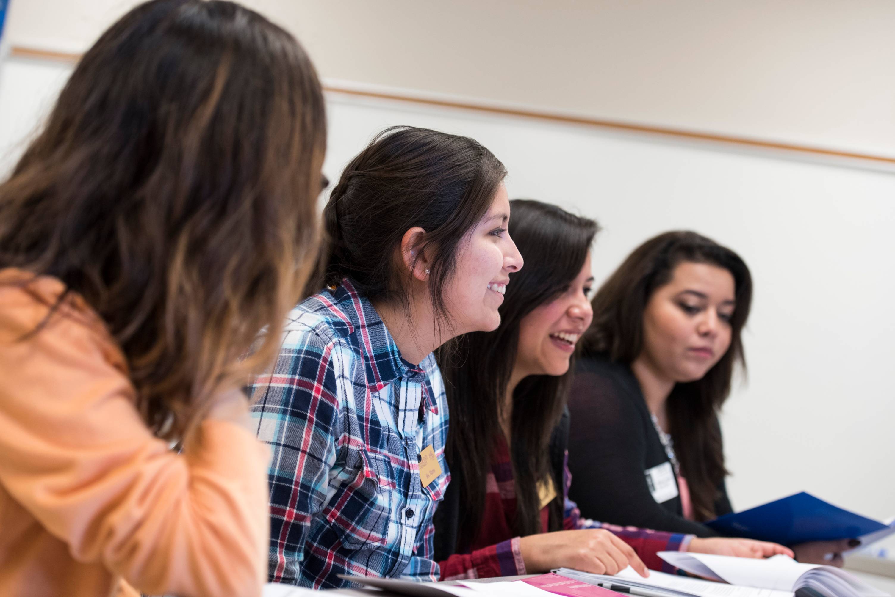 Students listen to a professor in a classroom.