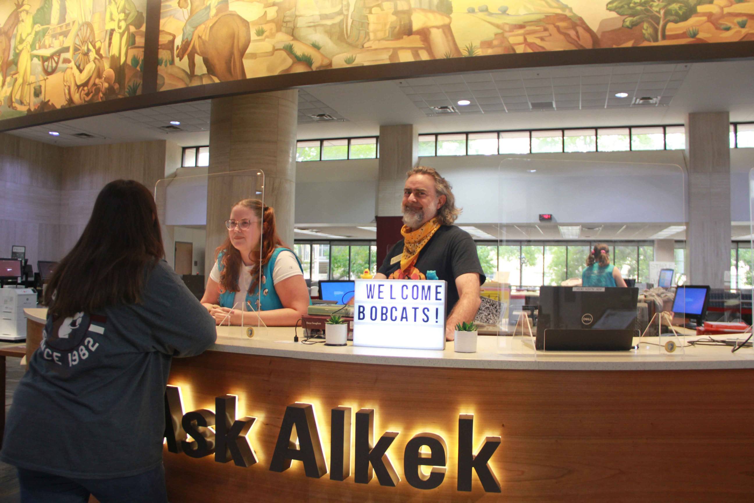 photo of two people at Ask Alkek desk