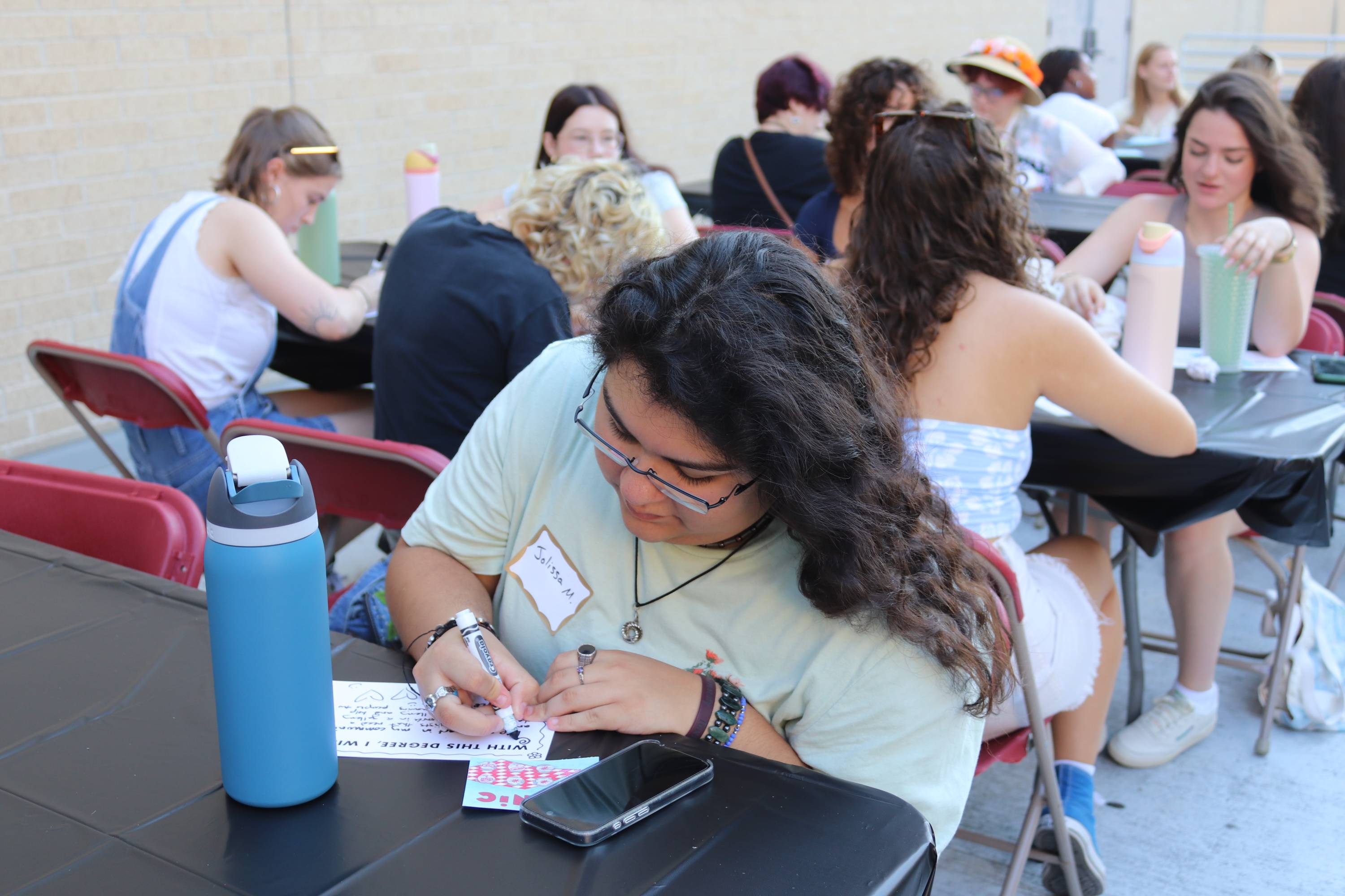 Students outside completing a writing activity