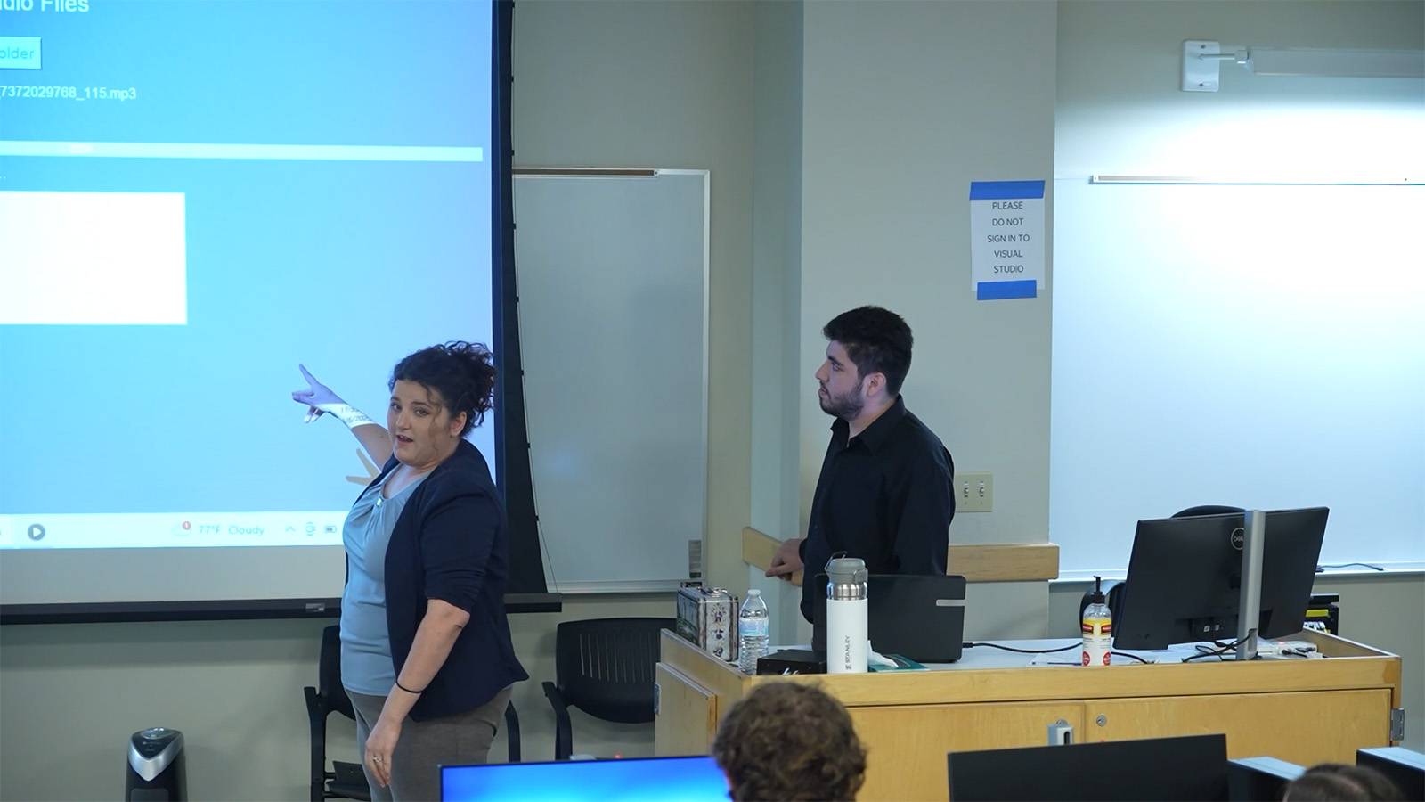 two students presenting a project during class