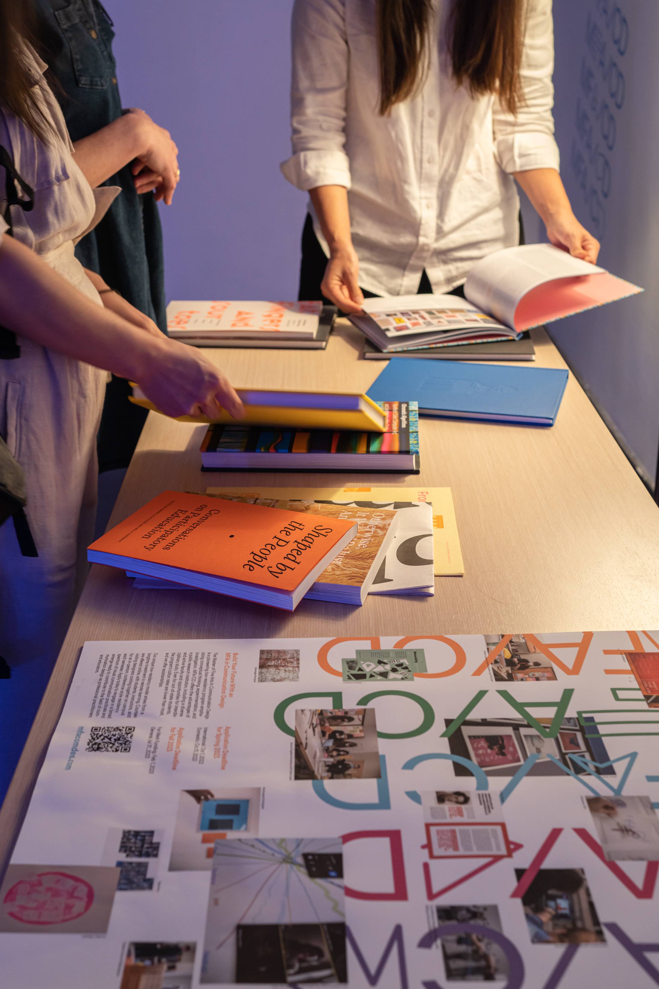 3 people reviewing design books