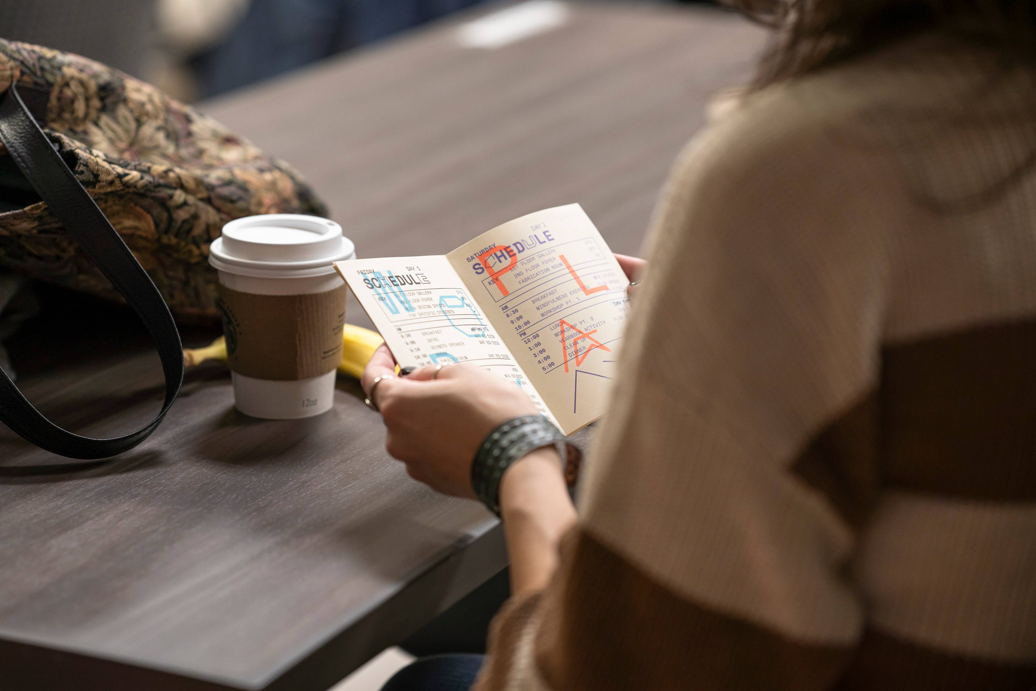 Someone reading a book with an event schedule