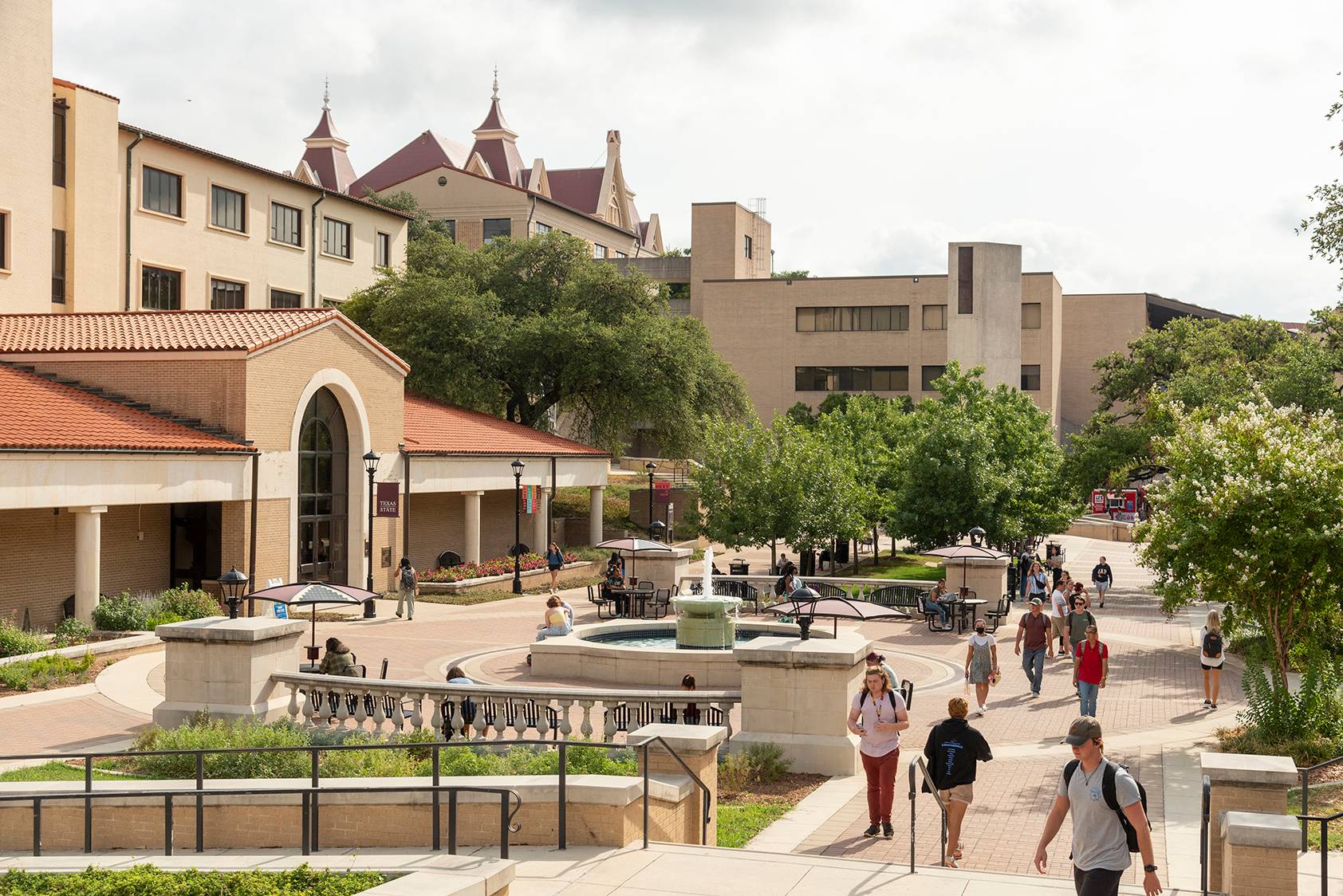 students walking on texas state university campus