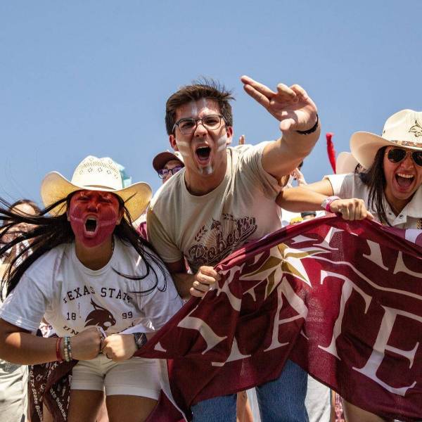 A group of passionate students cheering for Texas State University