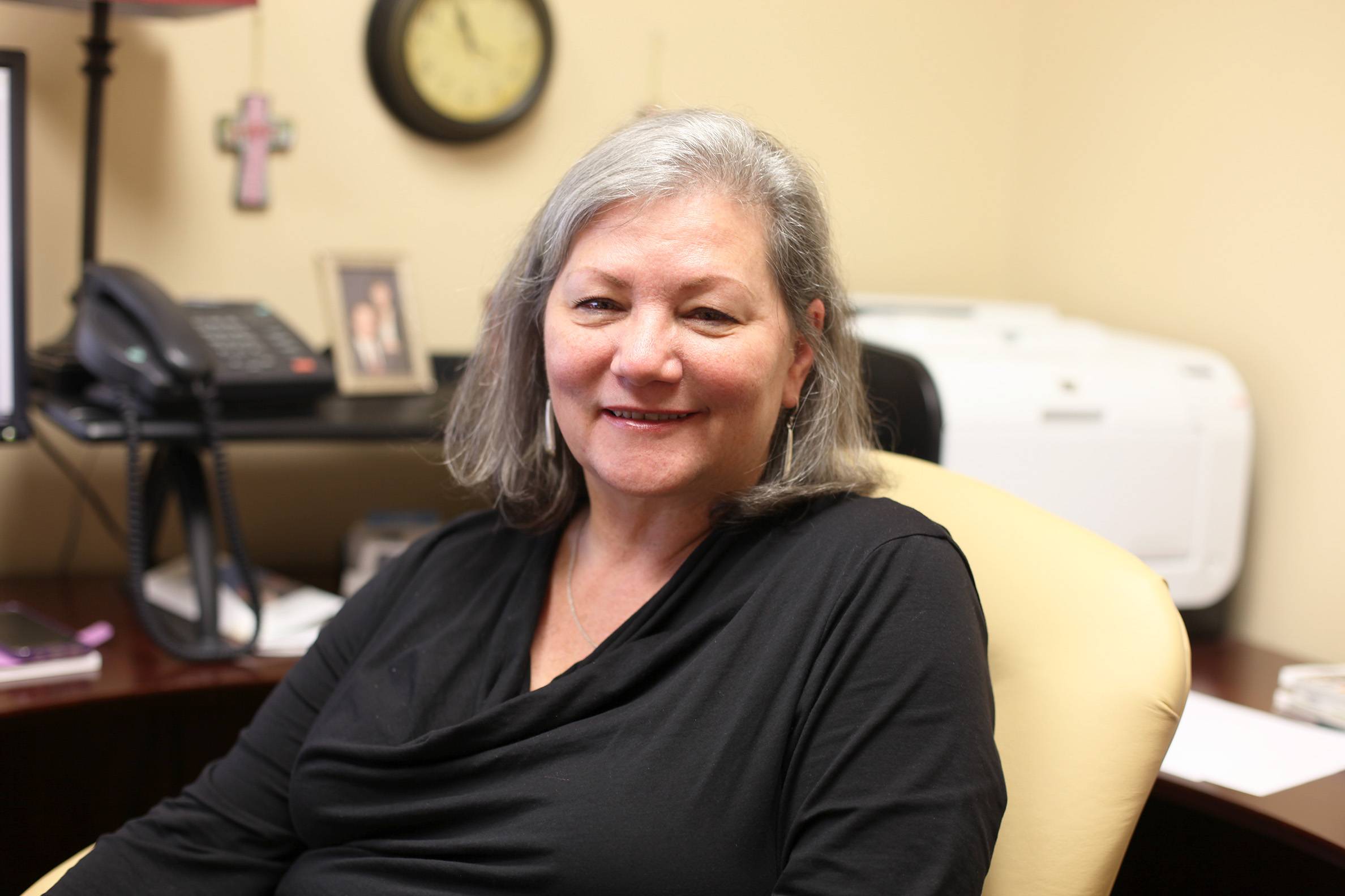 Photo of Vicky sitting in her office