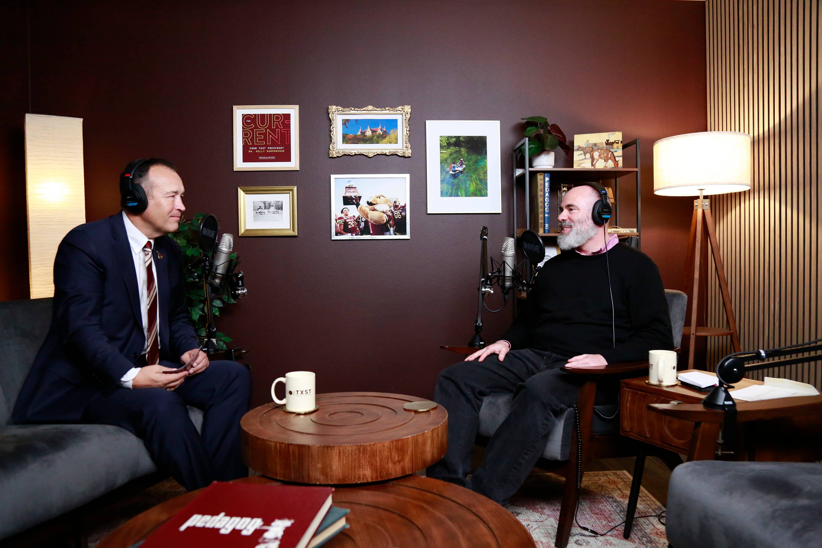 president damphousse speaking with man in podcast studio