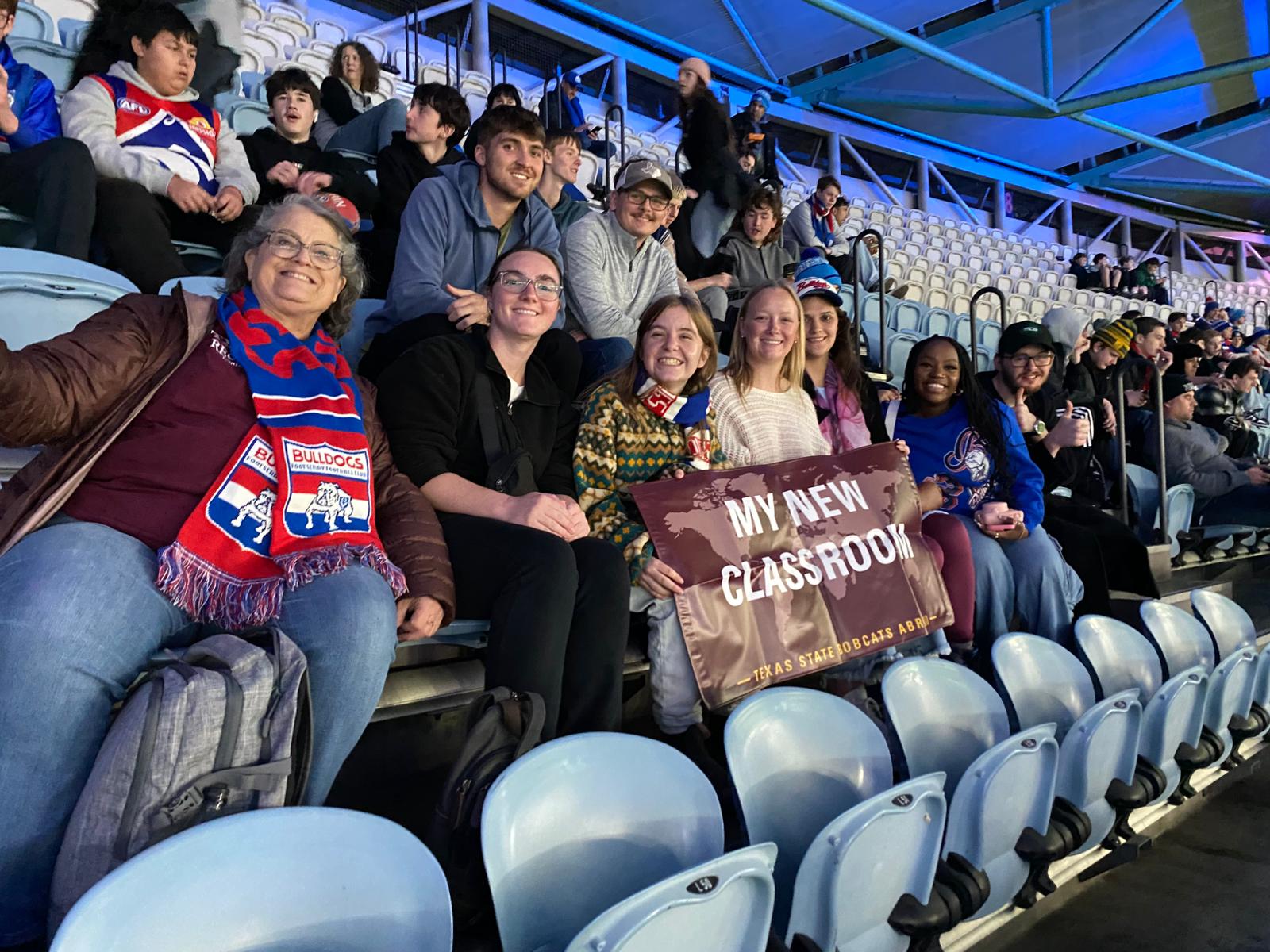 group of students sitting in stadium seats