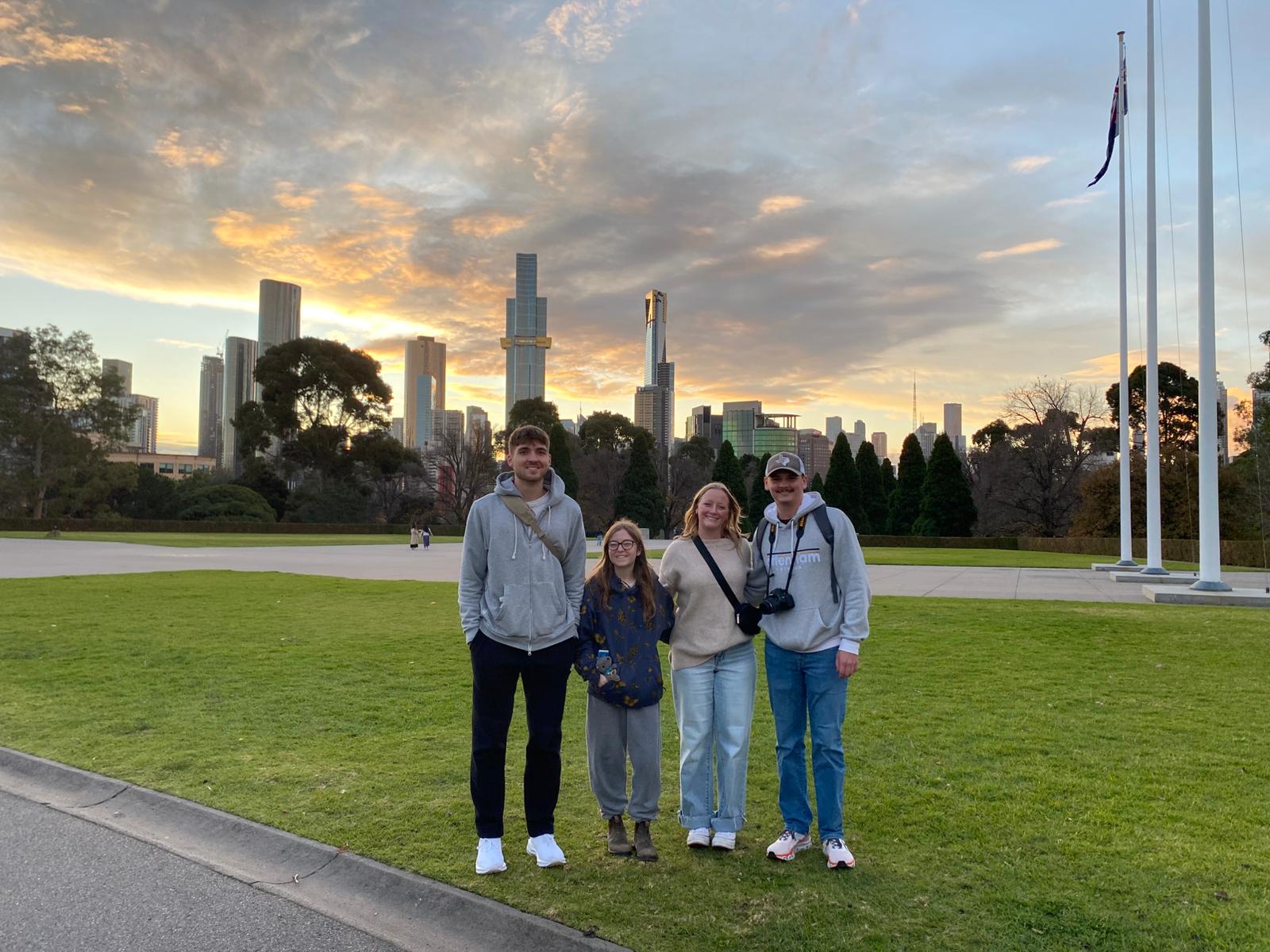 Group of students standing in front of Melbourne skyline