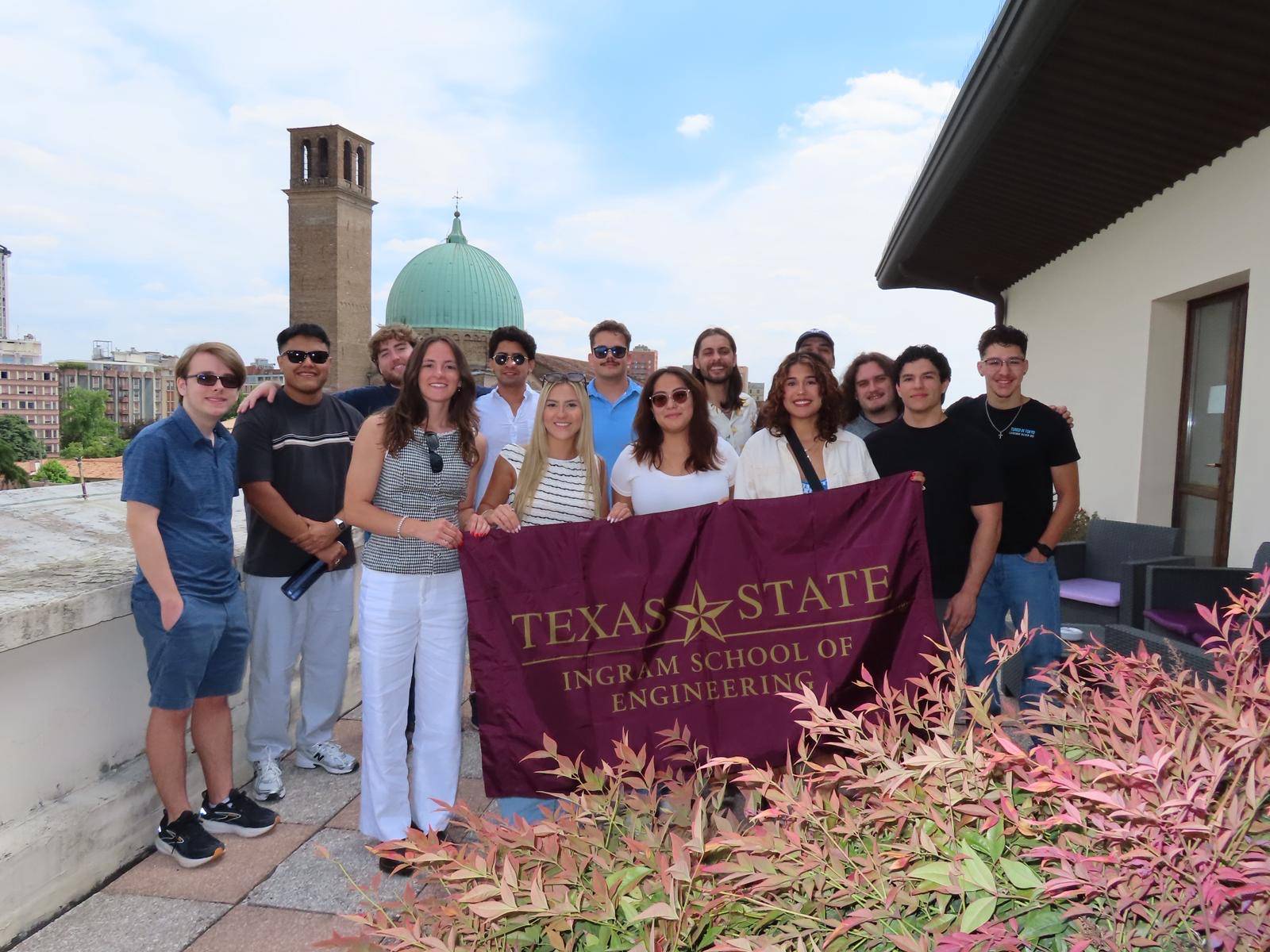 Ingram engineering students at Casa Al Carmine terrace with Texas State flag