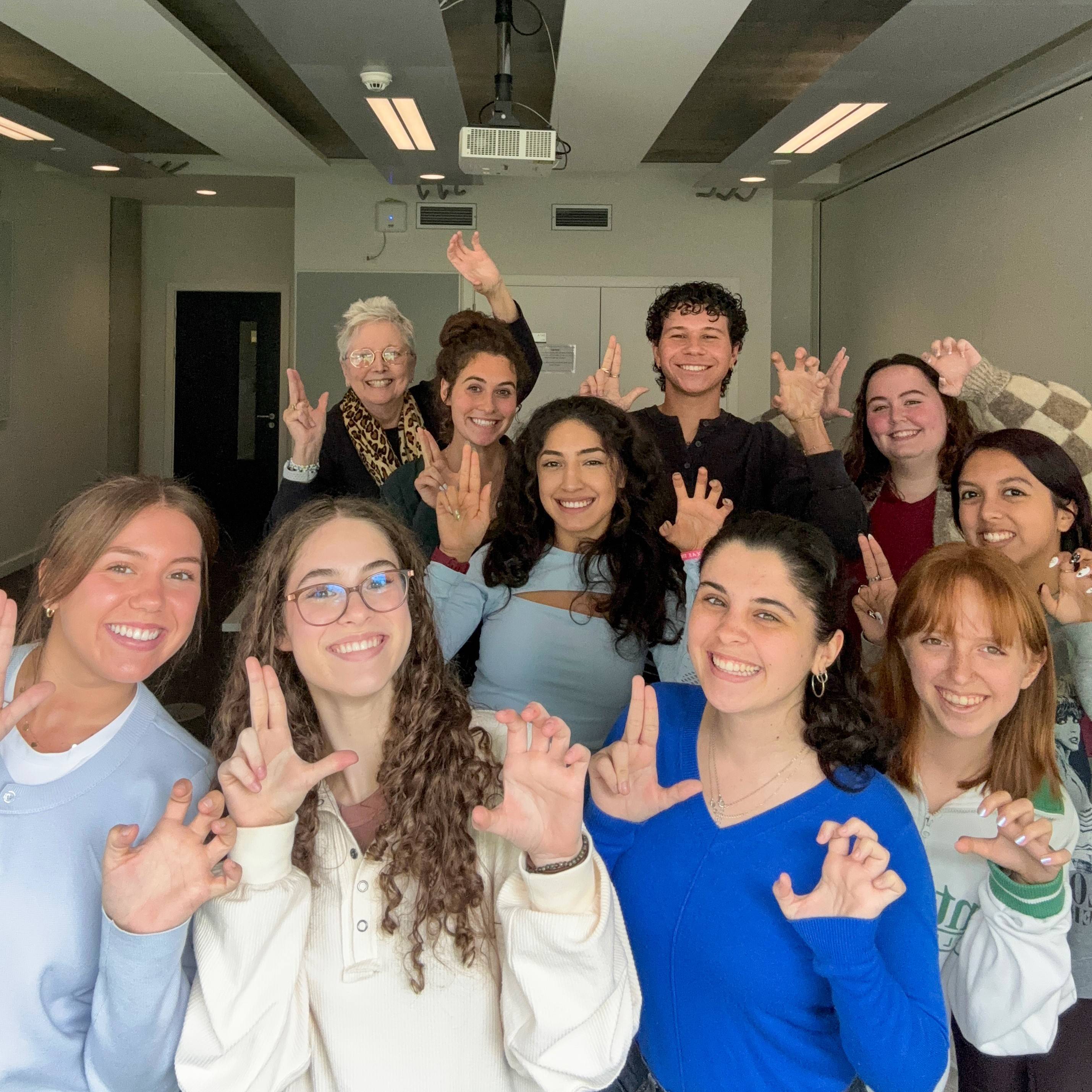 Group of students taking selfie in QMU classroom