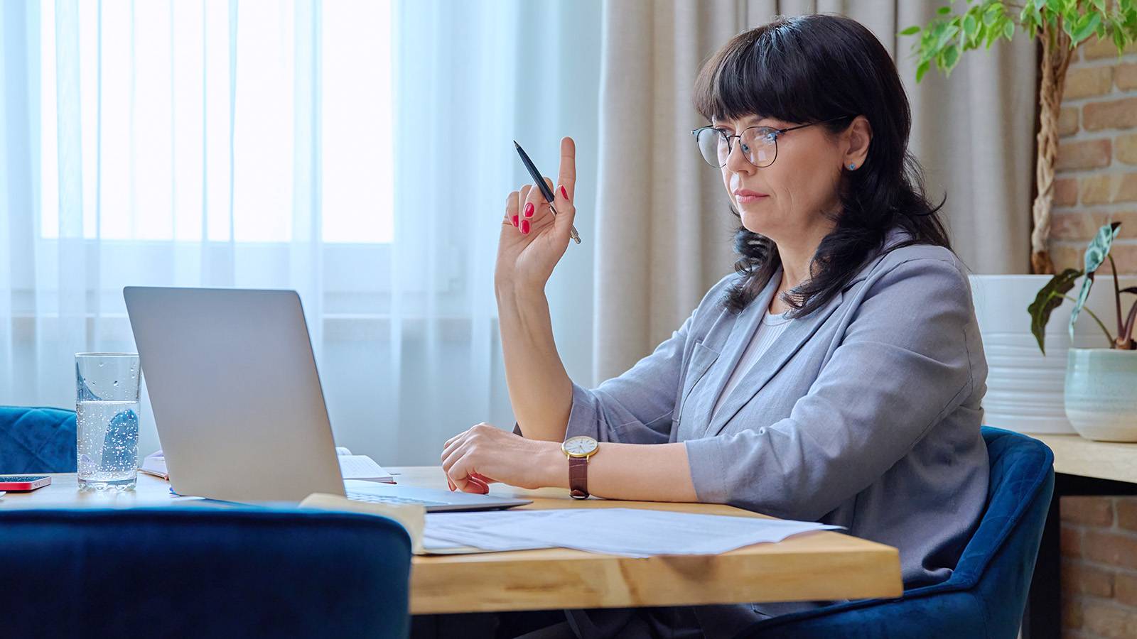 Woman working on laptop computer at desk