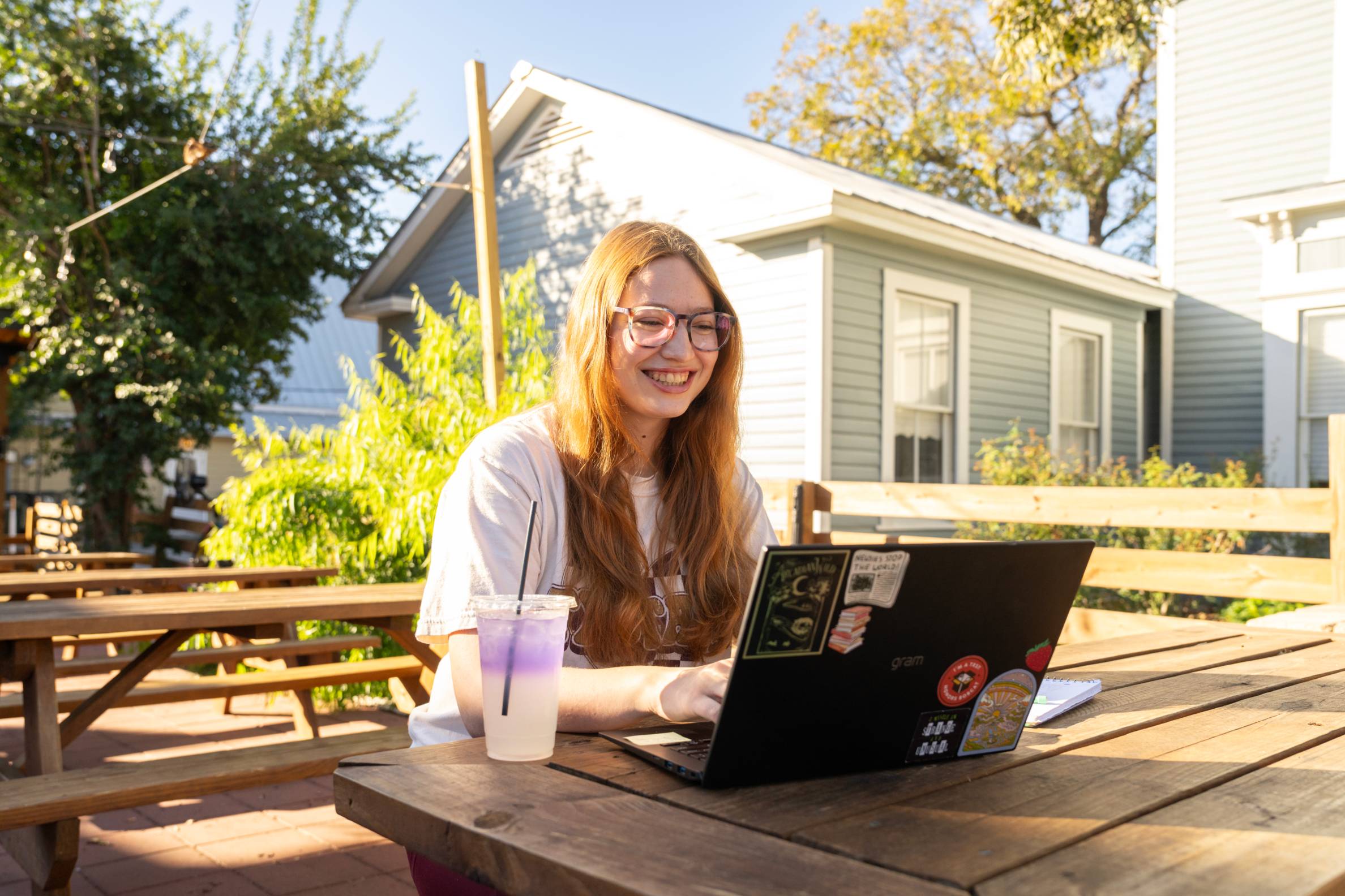 Student outdoors with a laptop