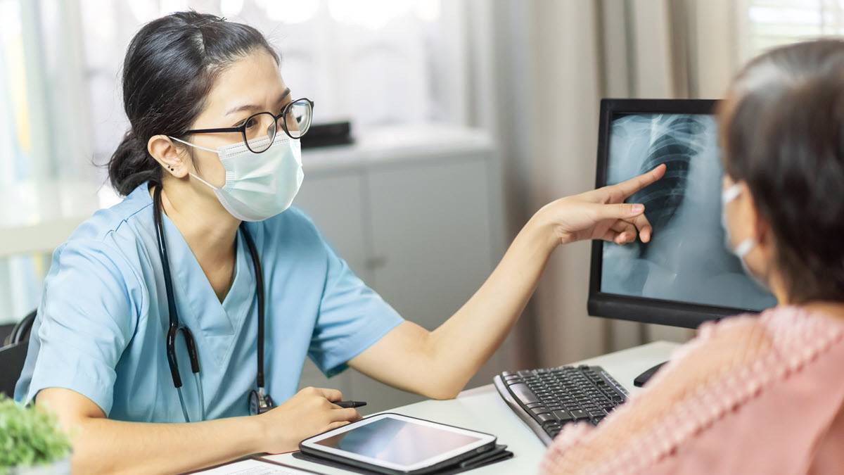 A healthcare provider showing a patient an x-ray
