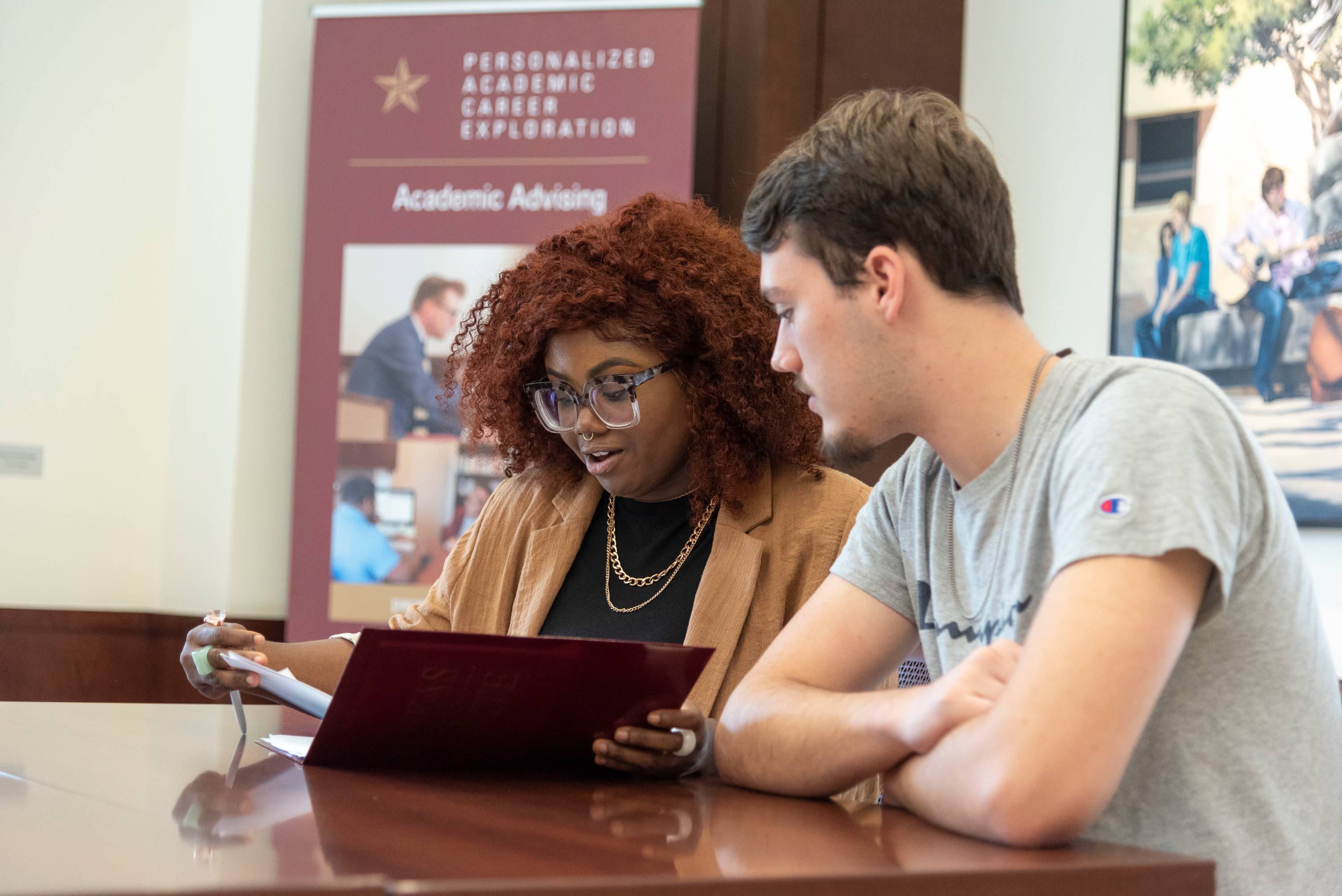 An advisor meets with a student