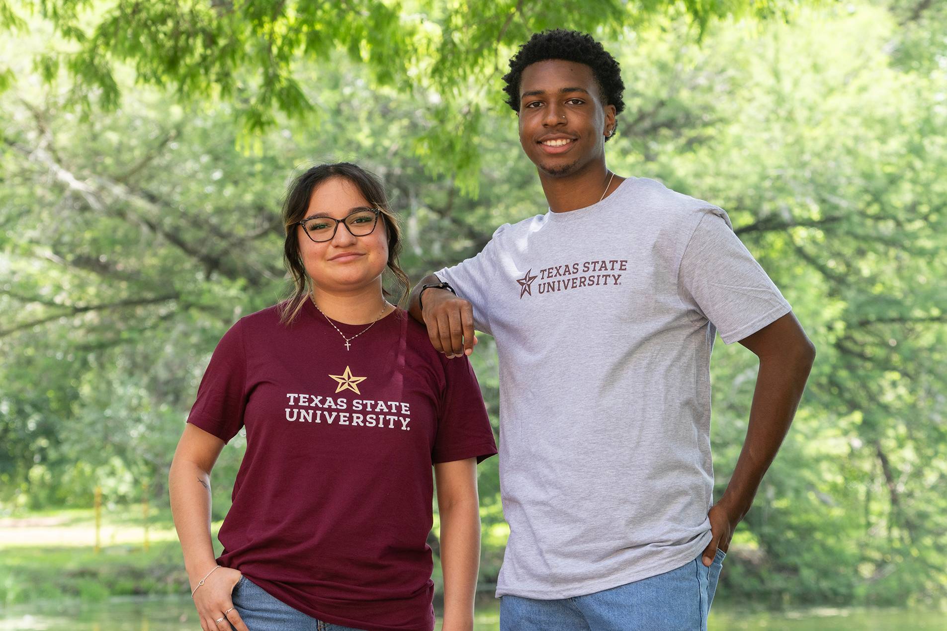 woman and man wearing shirts that read "Texas State University"