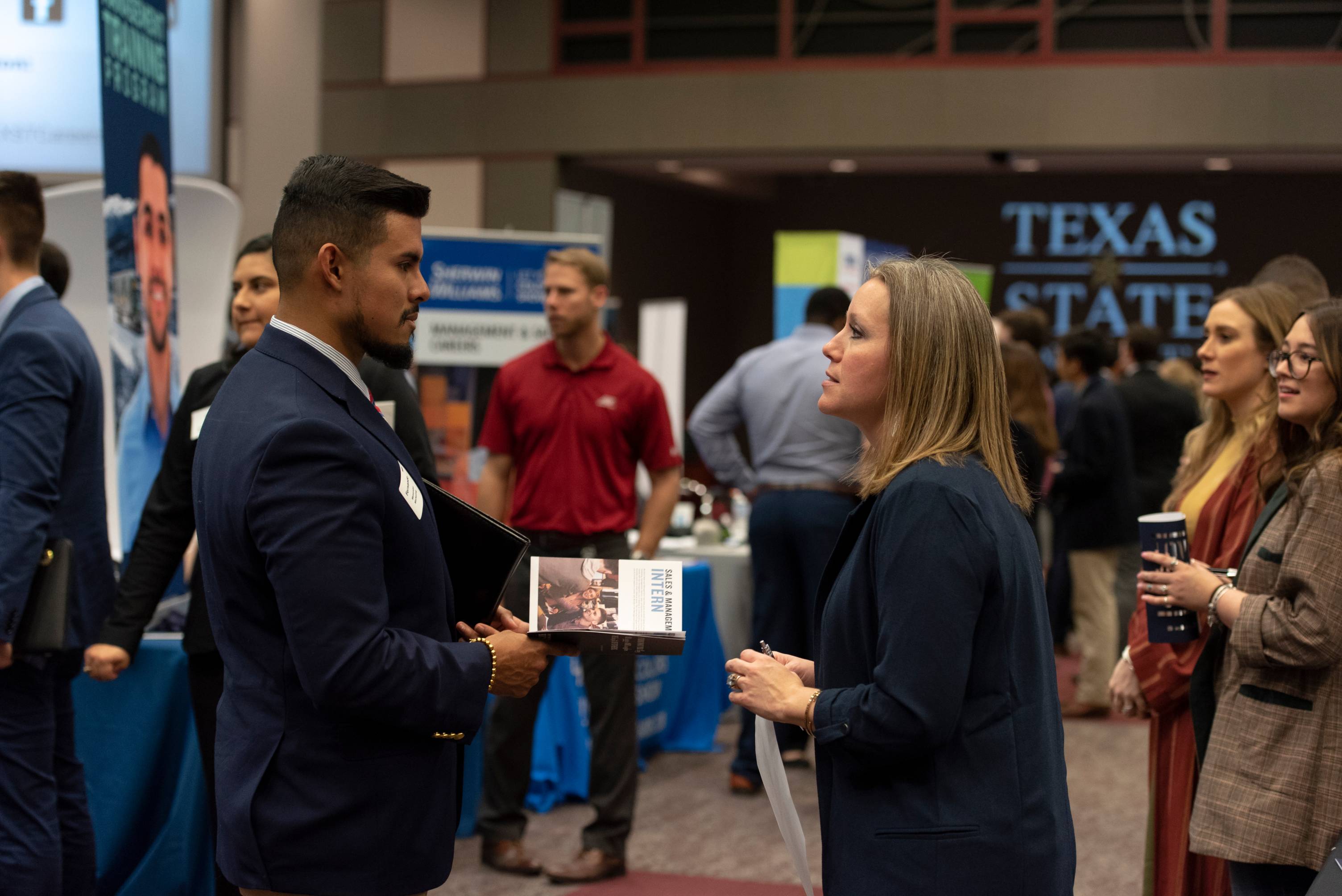 A student chats with an employer during a career fair