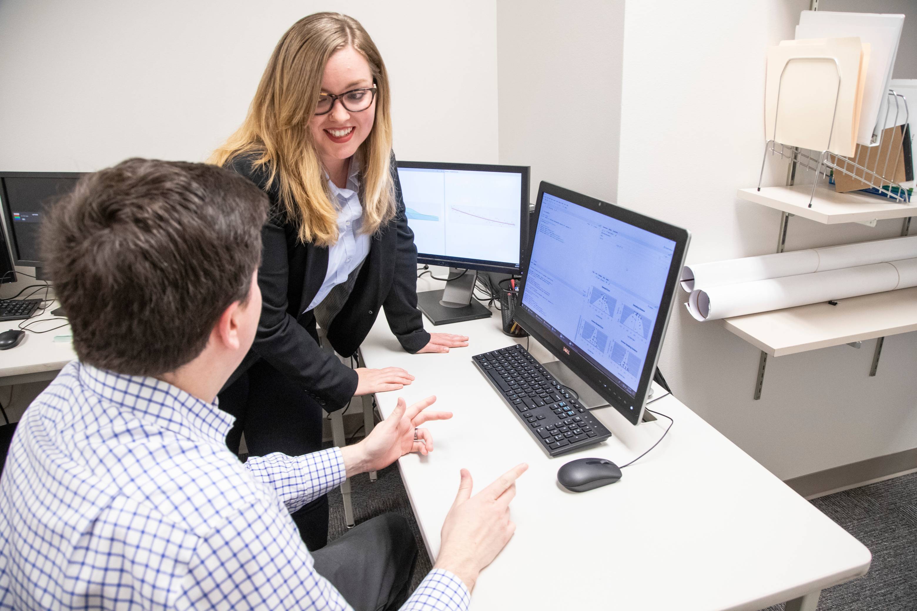 Two people discussing data on the computer. 