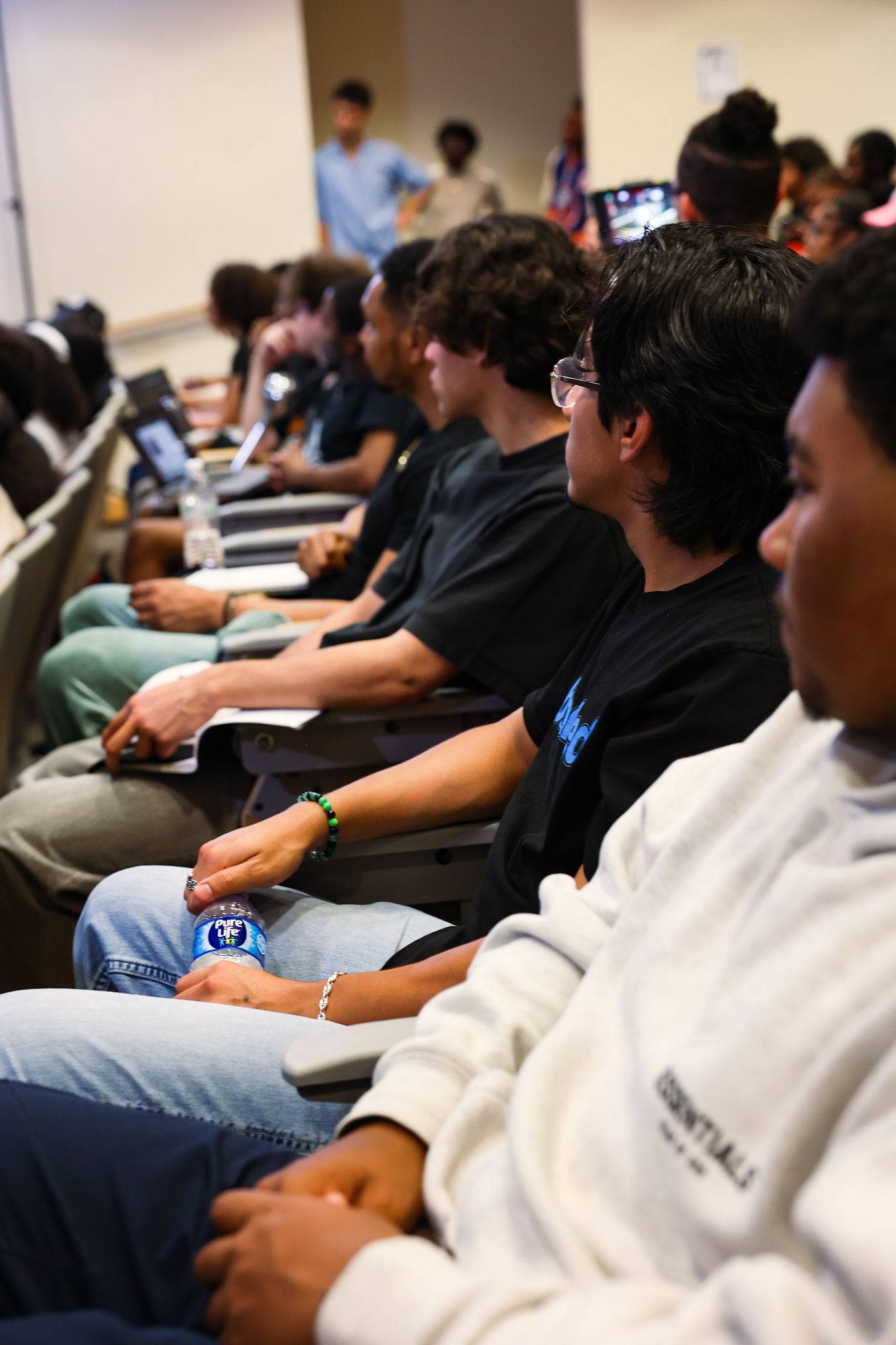 Row of students sitting and listening
