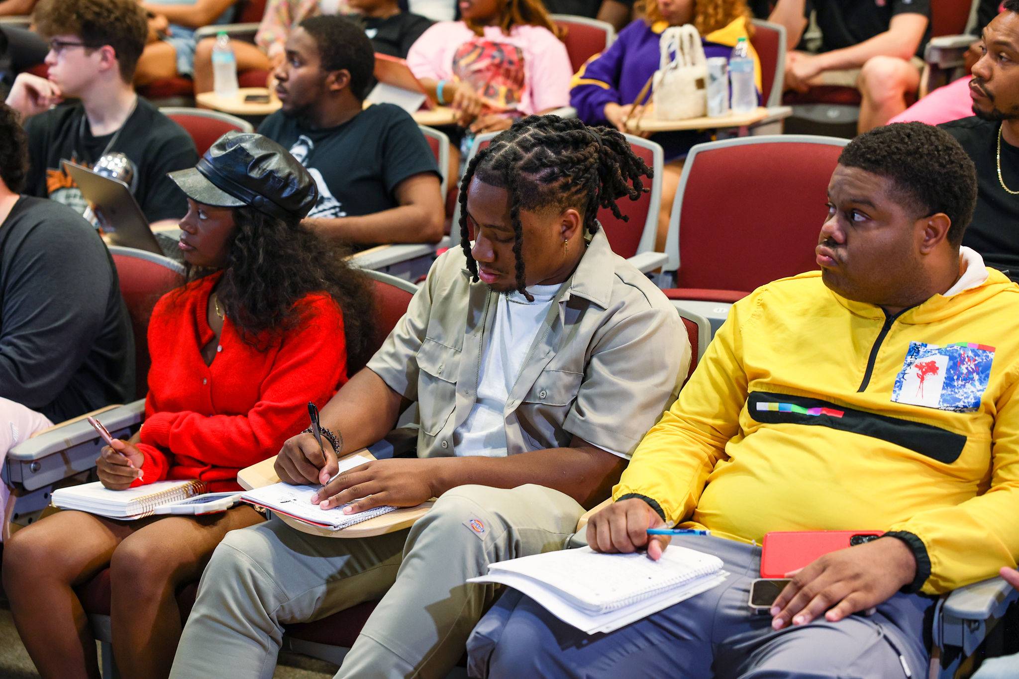 Students taking notes and listening