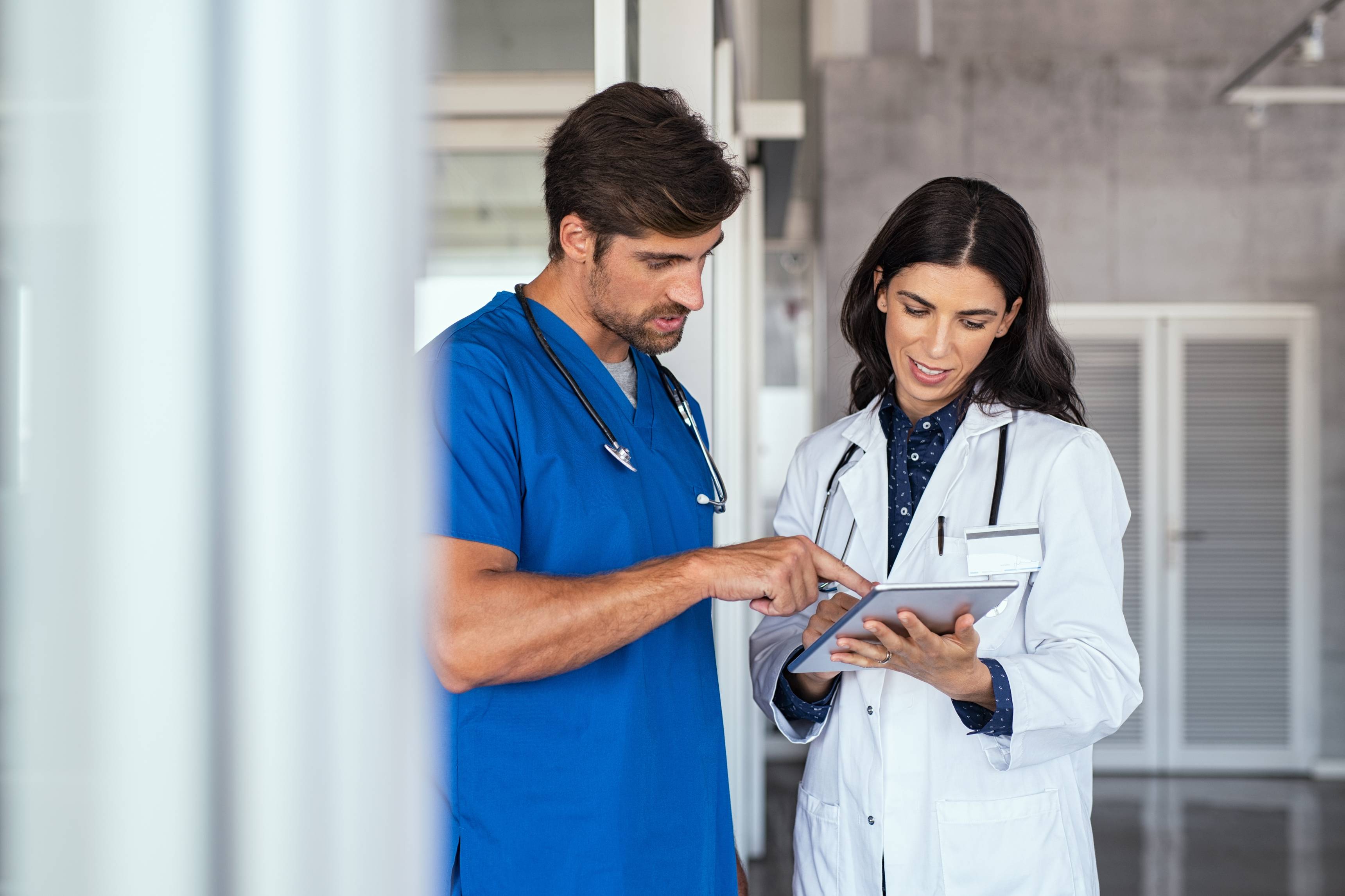 Doctor discussing what they are looking at with fellow nurse. 