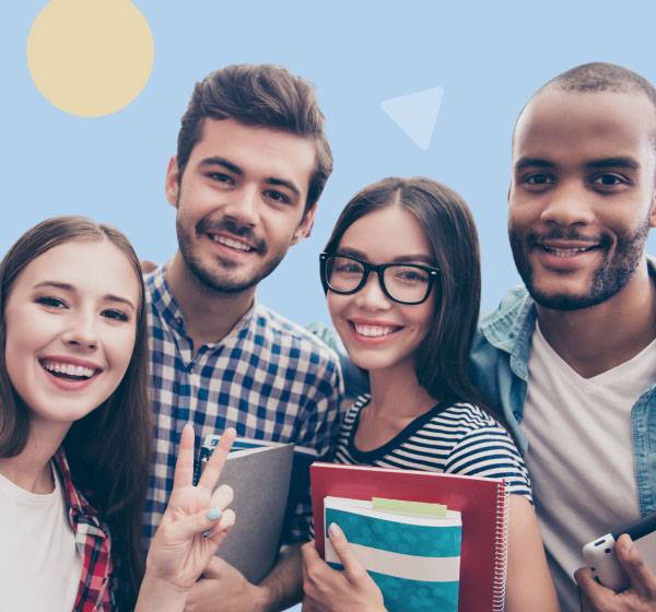 a group of four students smiling for a picture