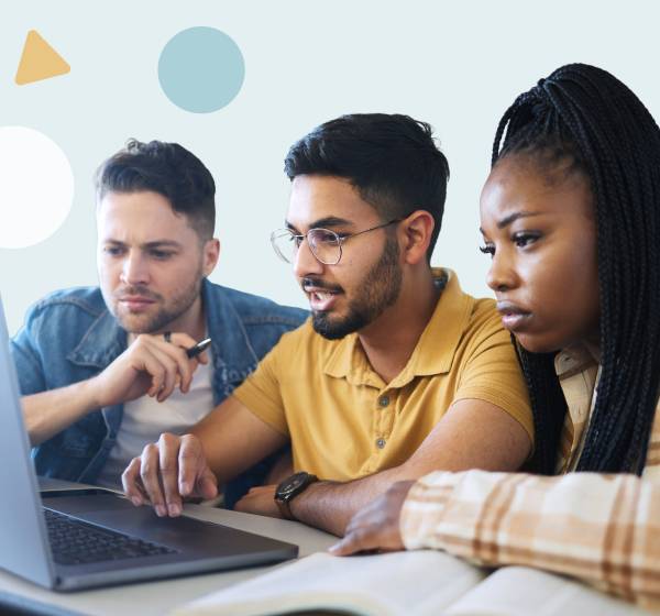 three people scrolling on a laptop
