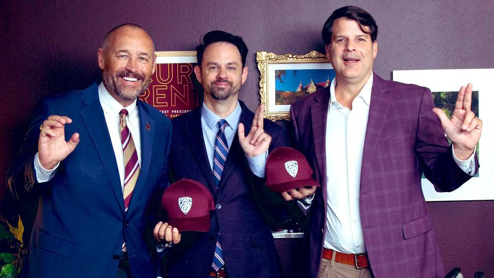 President Kelly Damphousse (left), Brant Freeman, and Don Coryell pose for a photo with TXST handsigns and Pac-12 hats.