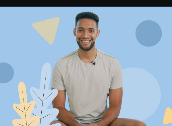 smiling person sitting with legs cross