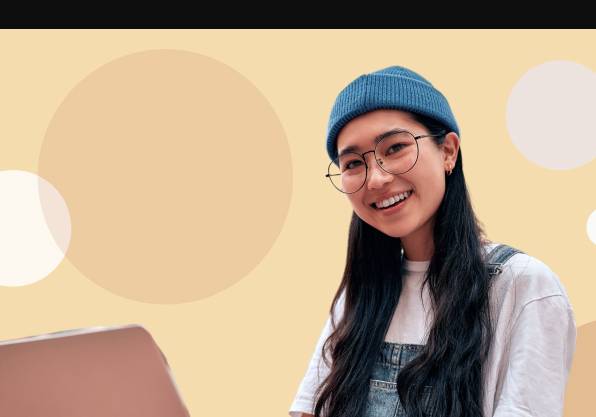 person sitting with legs crossed typing on a laptop