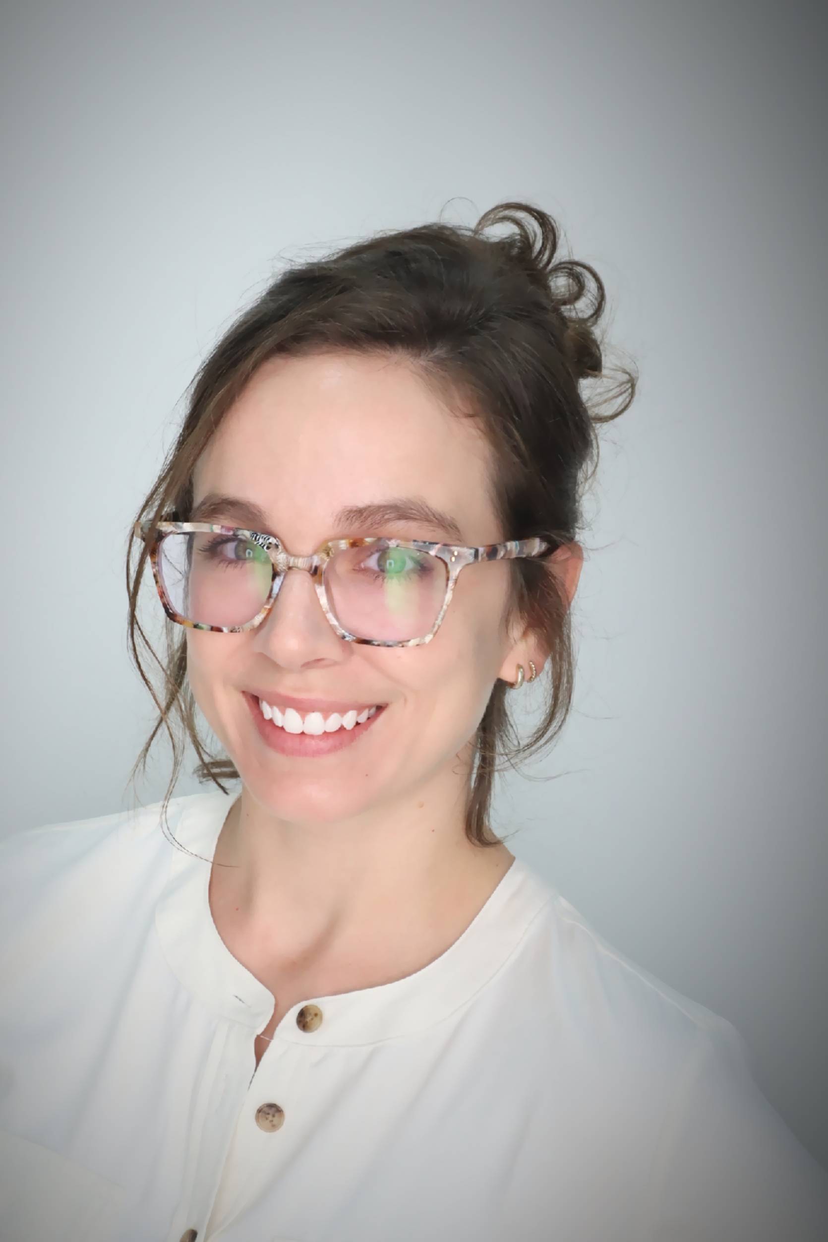 Marissa Trussell Headshot. Marissa smiling, wearing a white blouse.