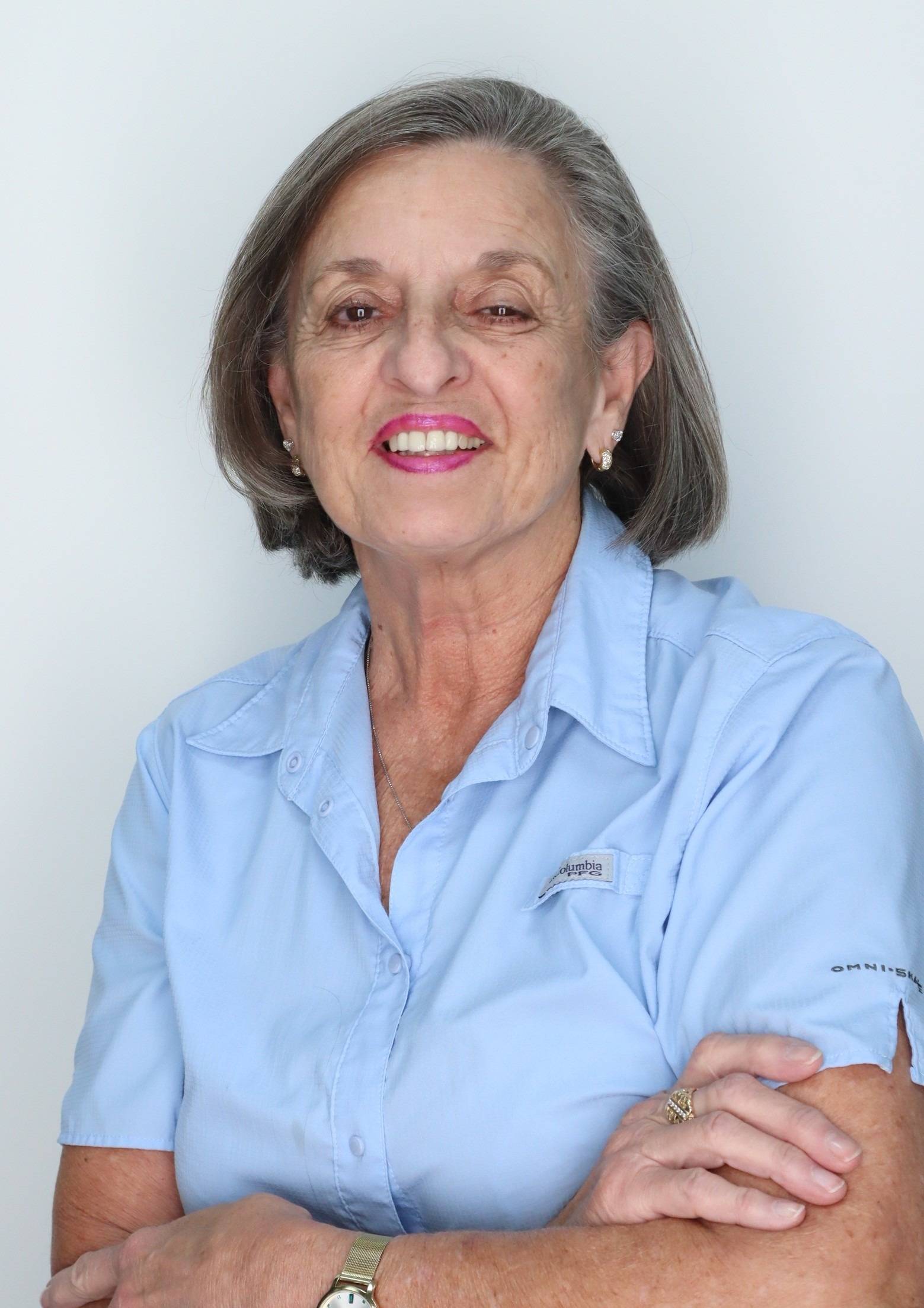 Sharon Fraker headshot, smiling, wearing a button up light blue blouse