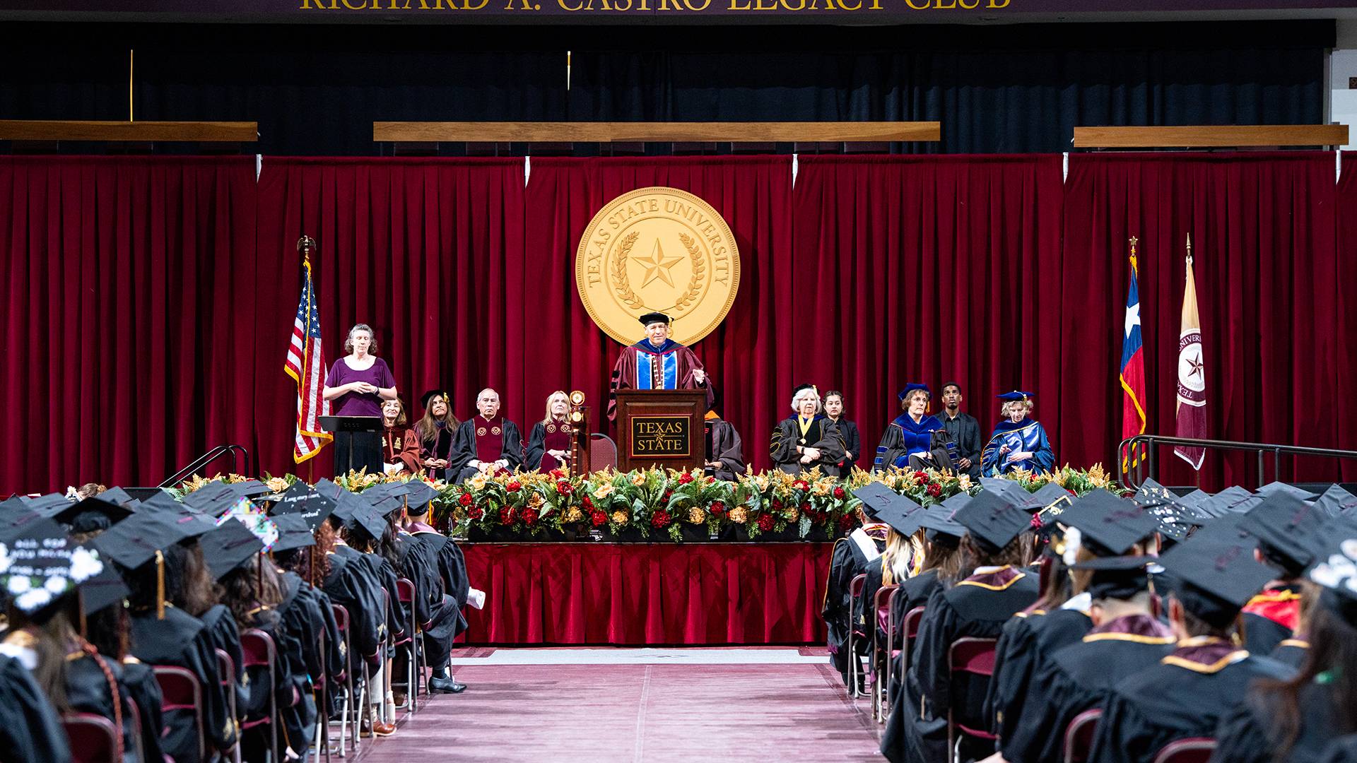 graduates sitting in a commencement chair