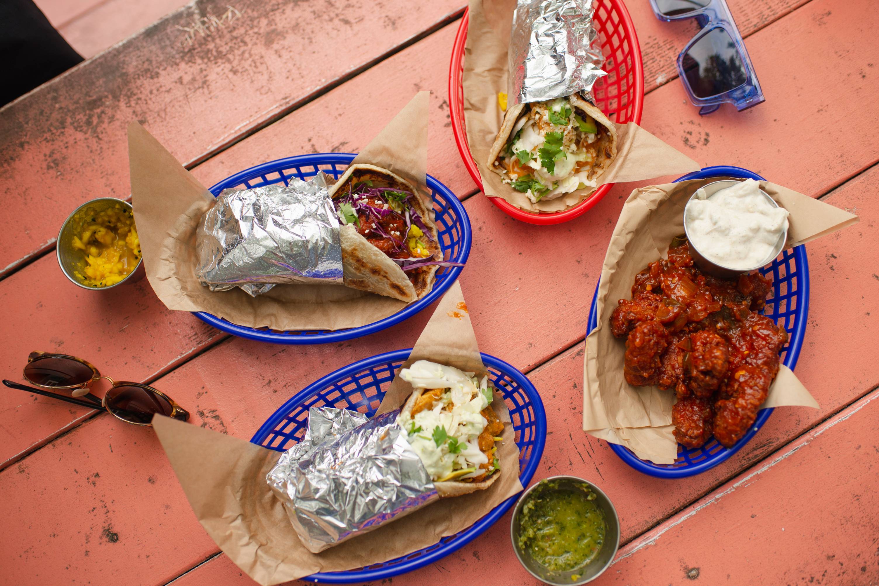 Aerial view of tacos on a peach colored table