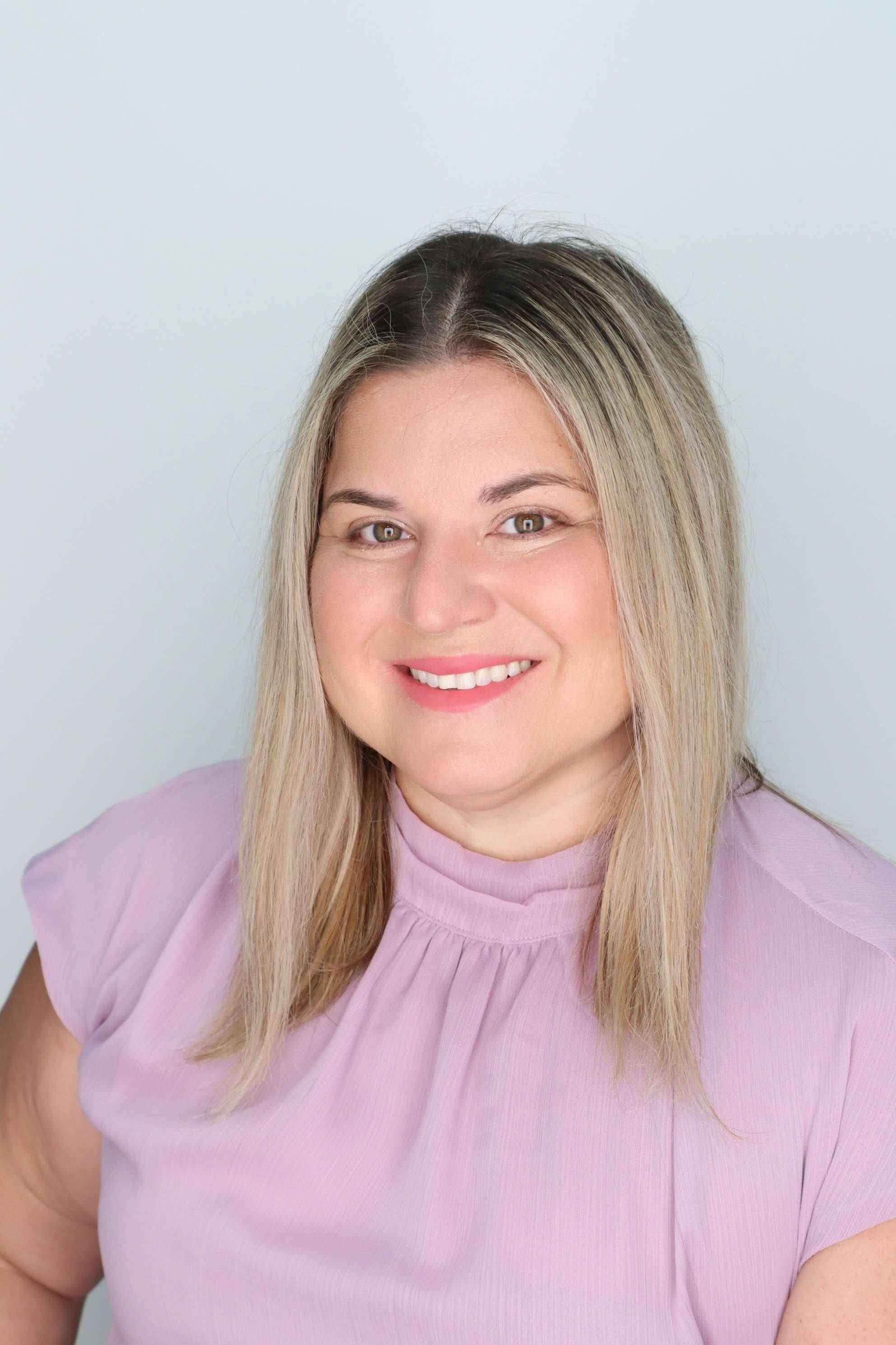 Headshot of Dr. Brenda Rodriguez wearing a lilac blouse