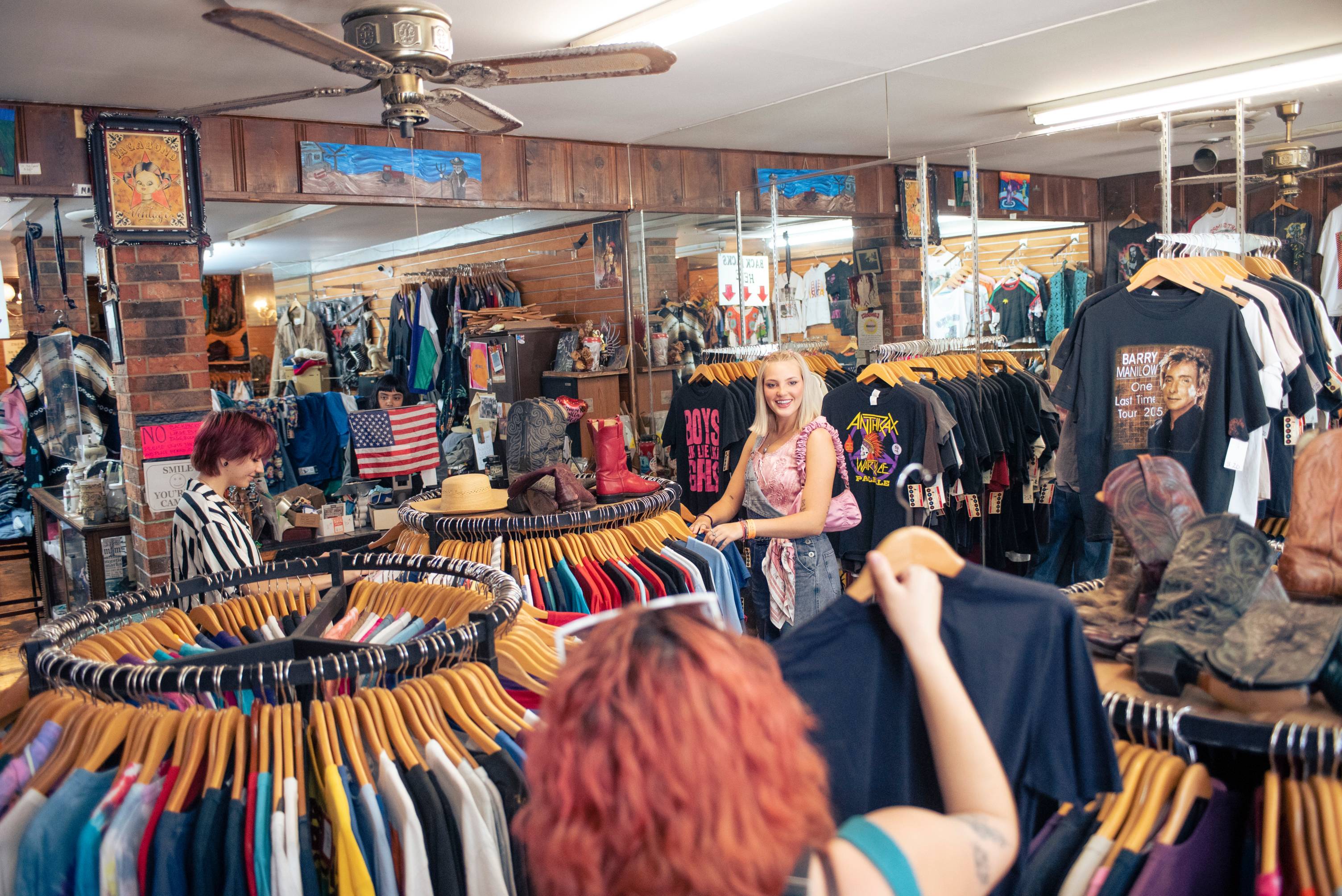 Vintage shop with racks of clothing and people shopping