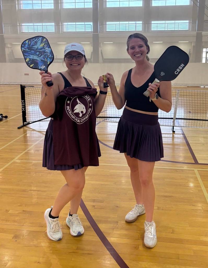 pickleball doubles championships holding paddles and intramural champ shirt