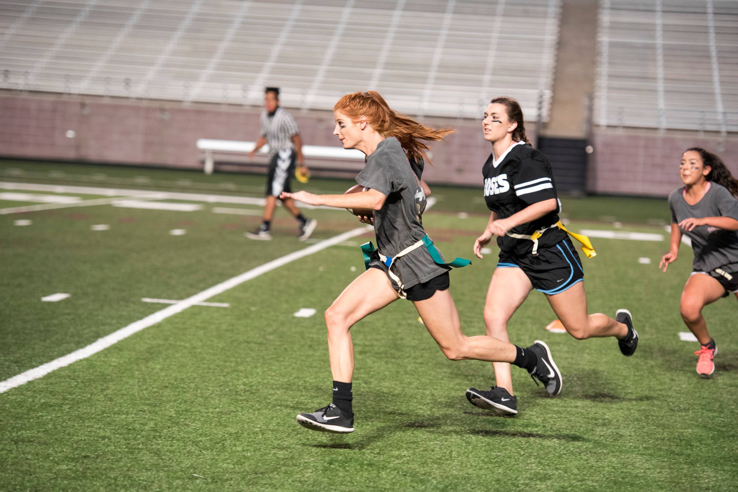 Image of student athletes running on a field.