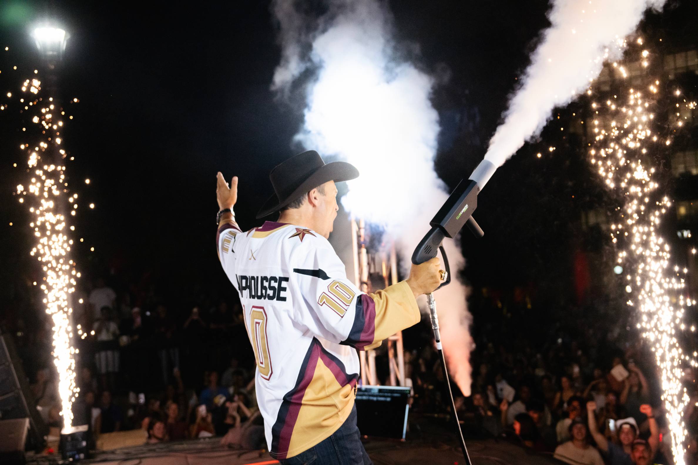 Photo of President Damphousse using a t-shirt blaster.
