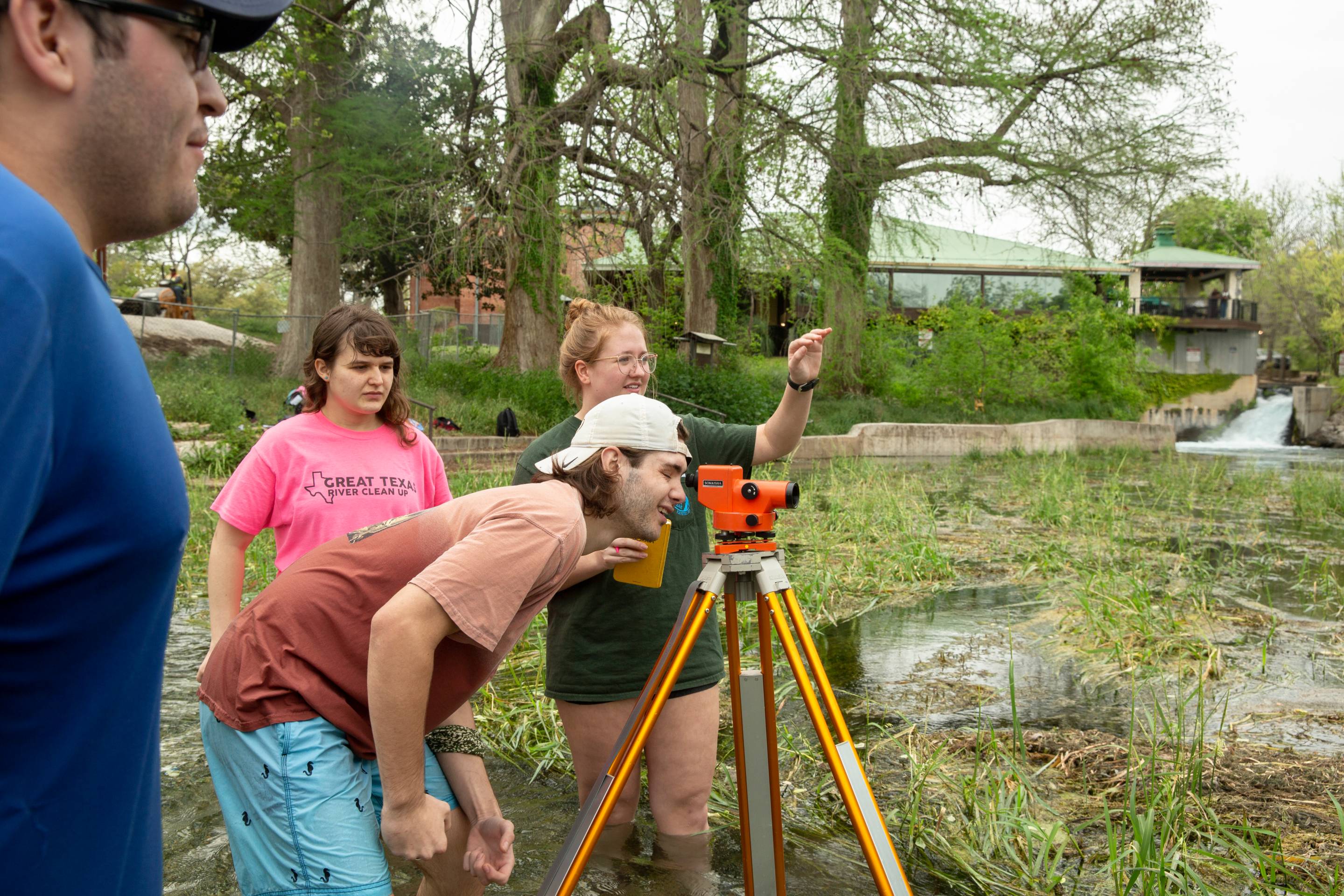 Students performing tests in river.