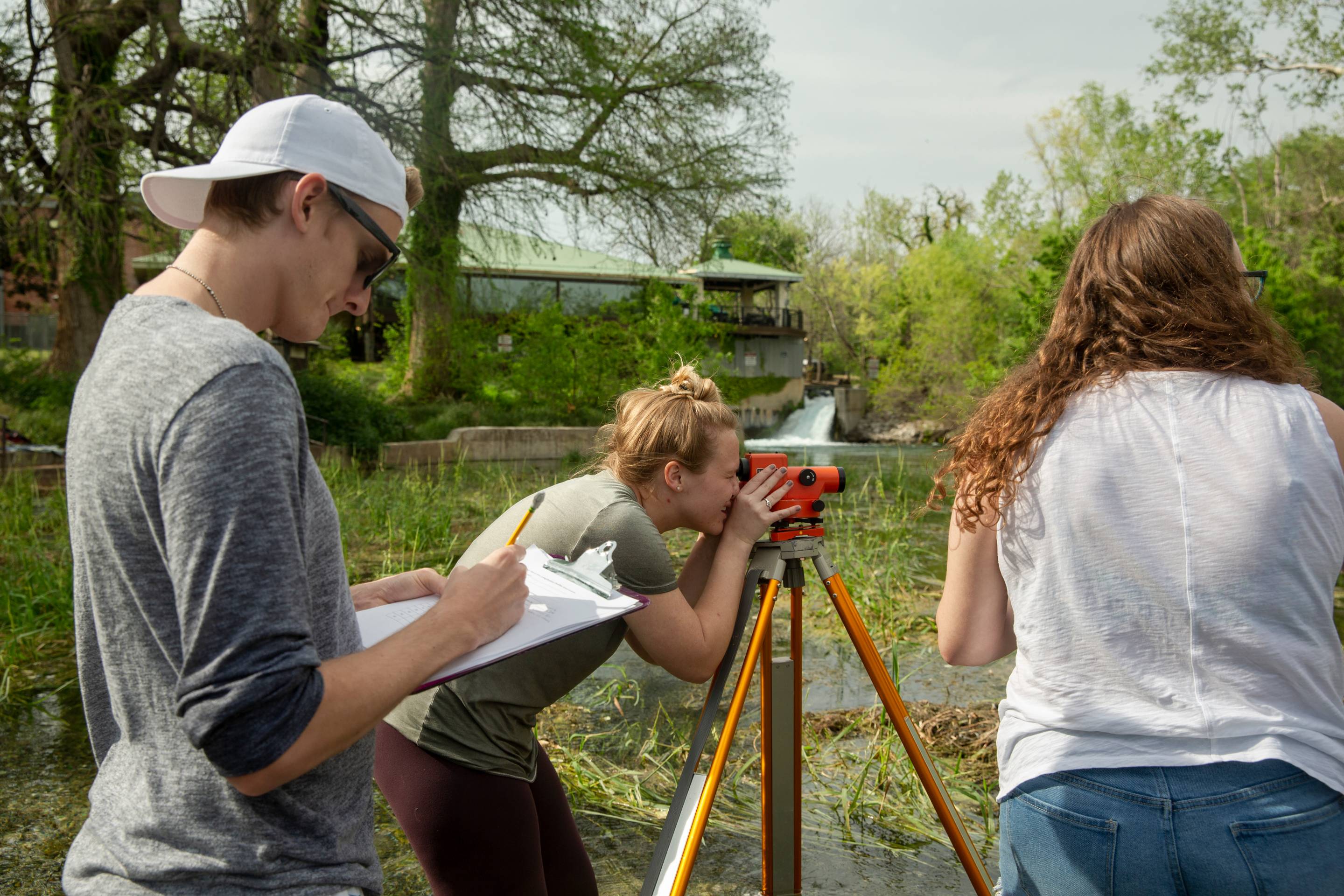 Students doing field work in a river. 