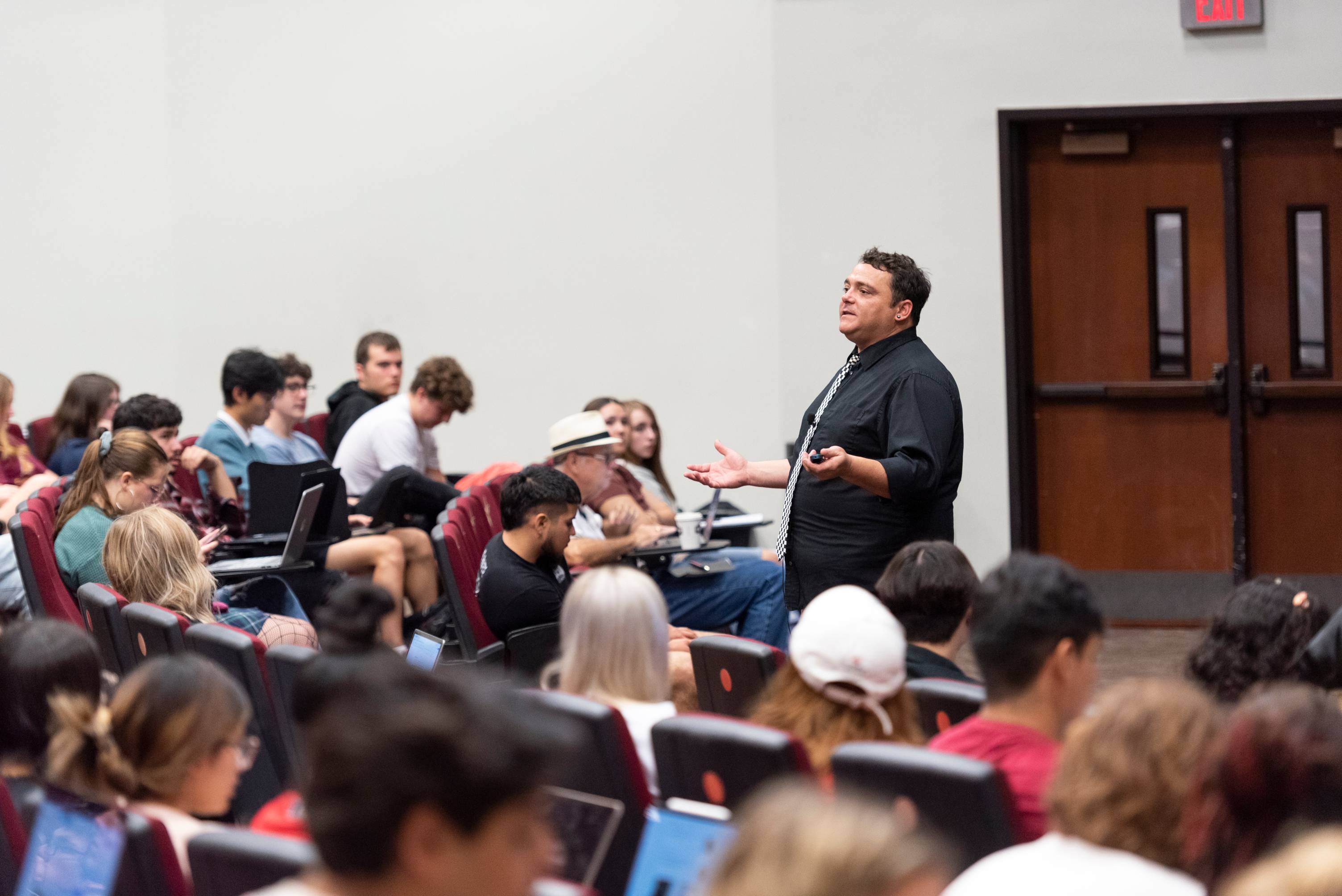 a professor speaking to students in a lecture hall