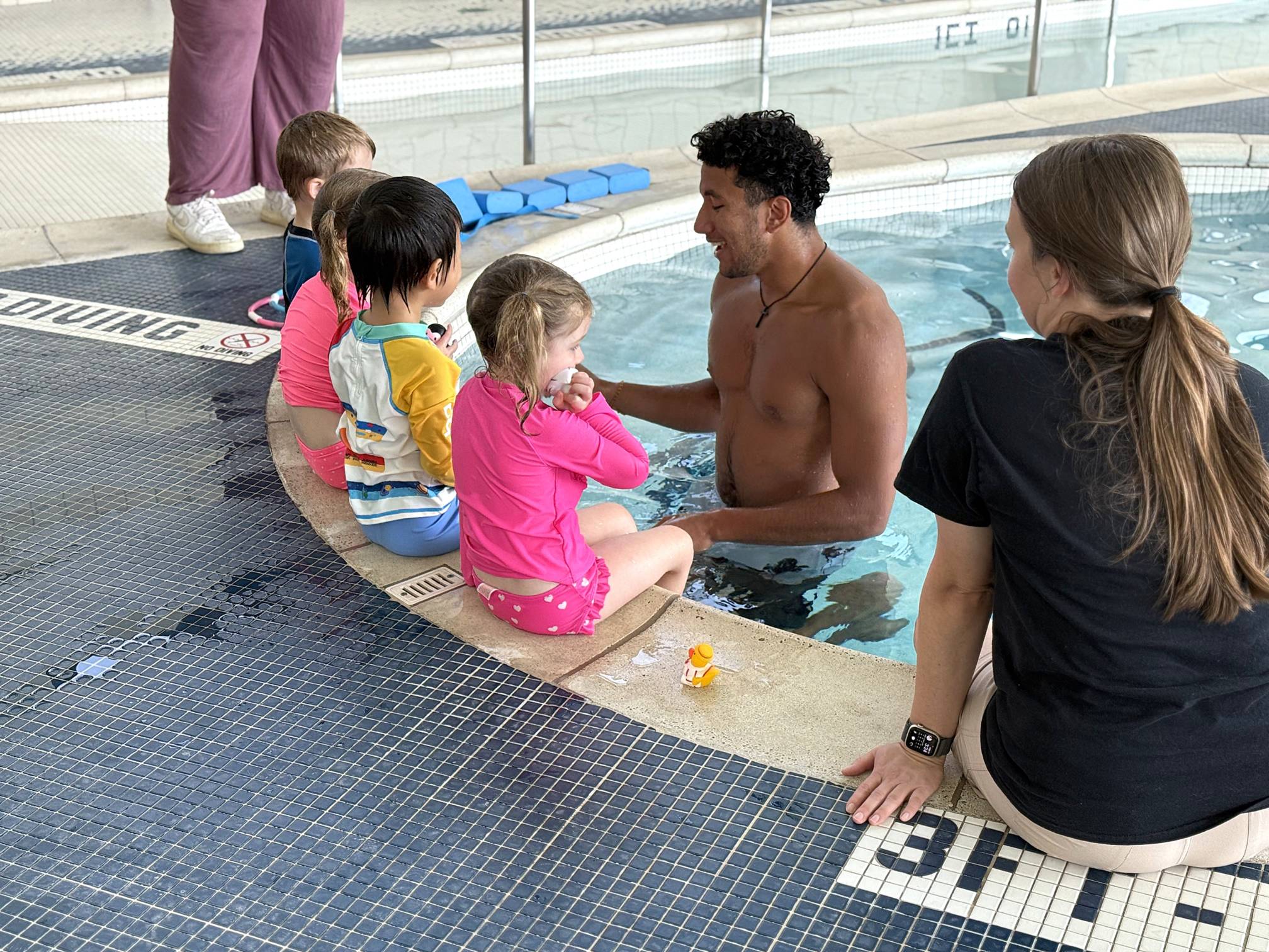 WSI helping child swim to the wall. 